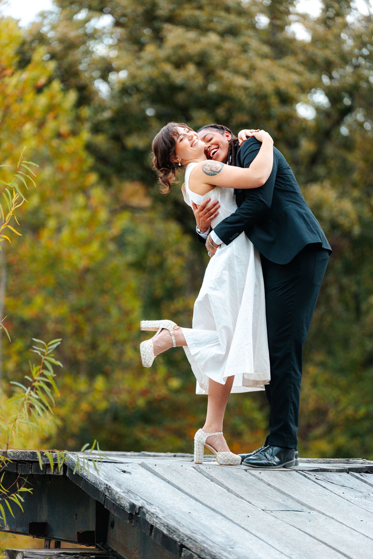 Romantic couple in formal attire dancing and dipping on a rooftop at sunset. wedding photography st louis