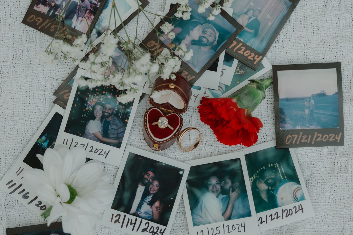 A collage wall filled with polaroid photos, string lights, and red flowers creating a nostalgic memory display.