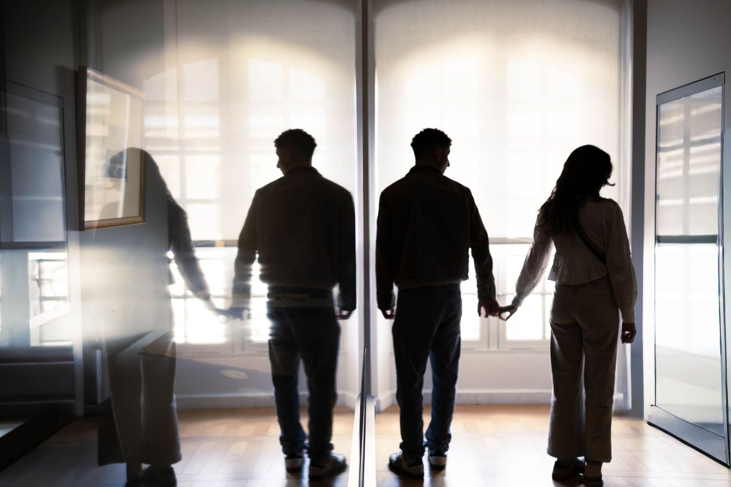 Photo en contre jour d'un jeune couple qui se tien la main