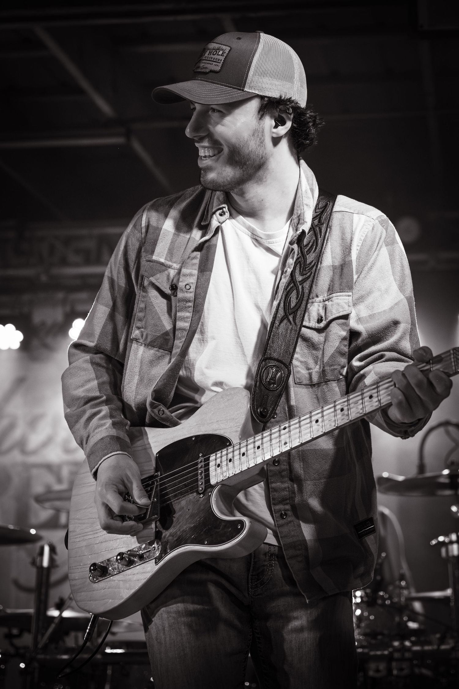 Black and white shots of guitar players performing on stage with instruments. Nashville Pipeline.