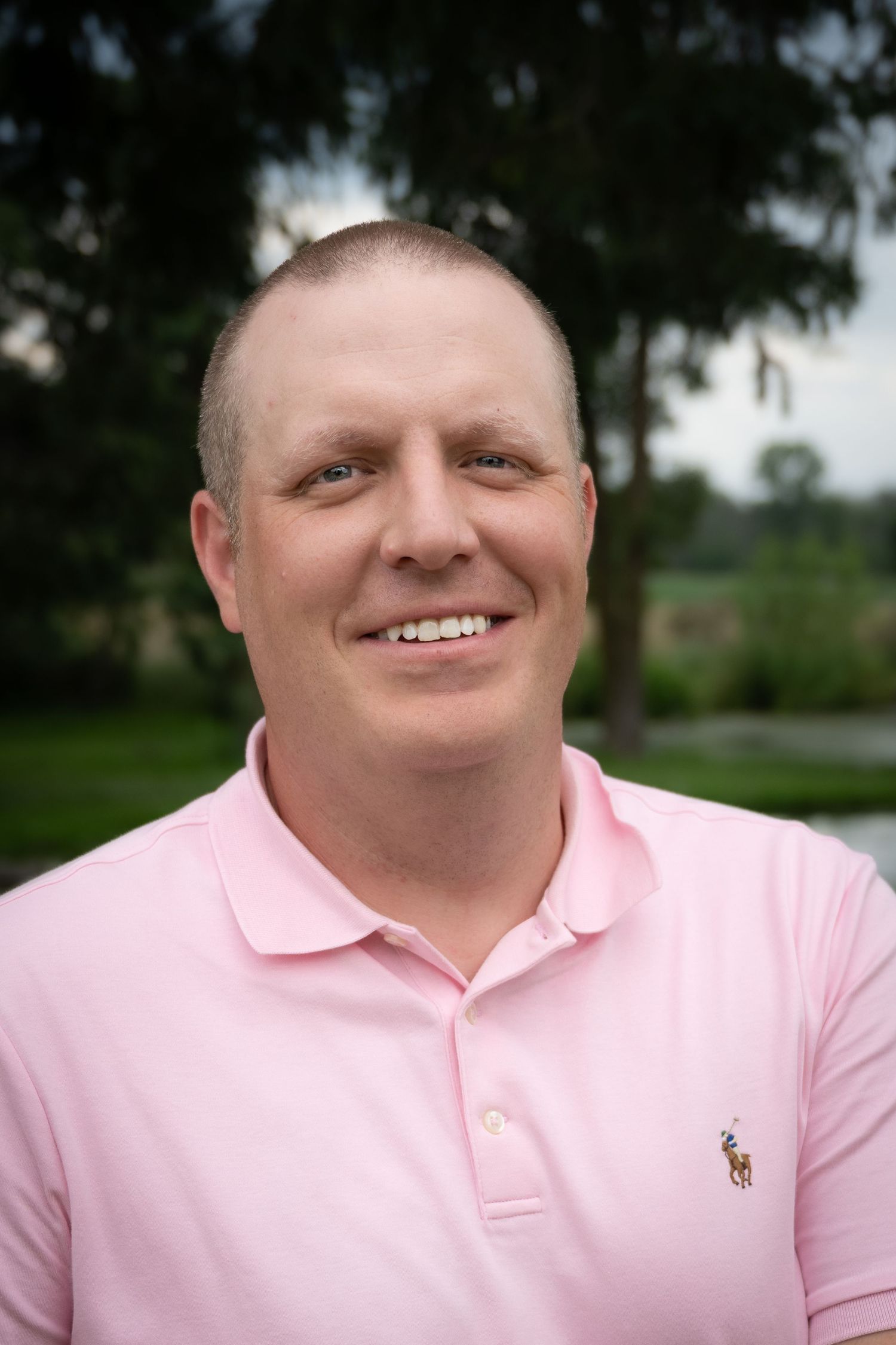 Portrait series showing different expressions in a pink polo shirt.