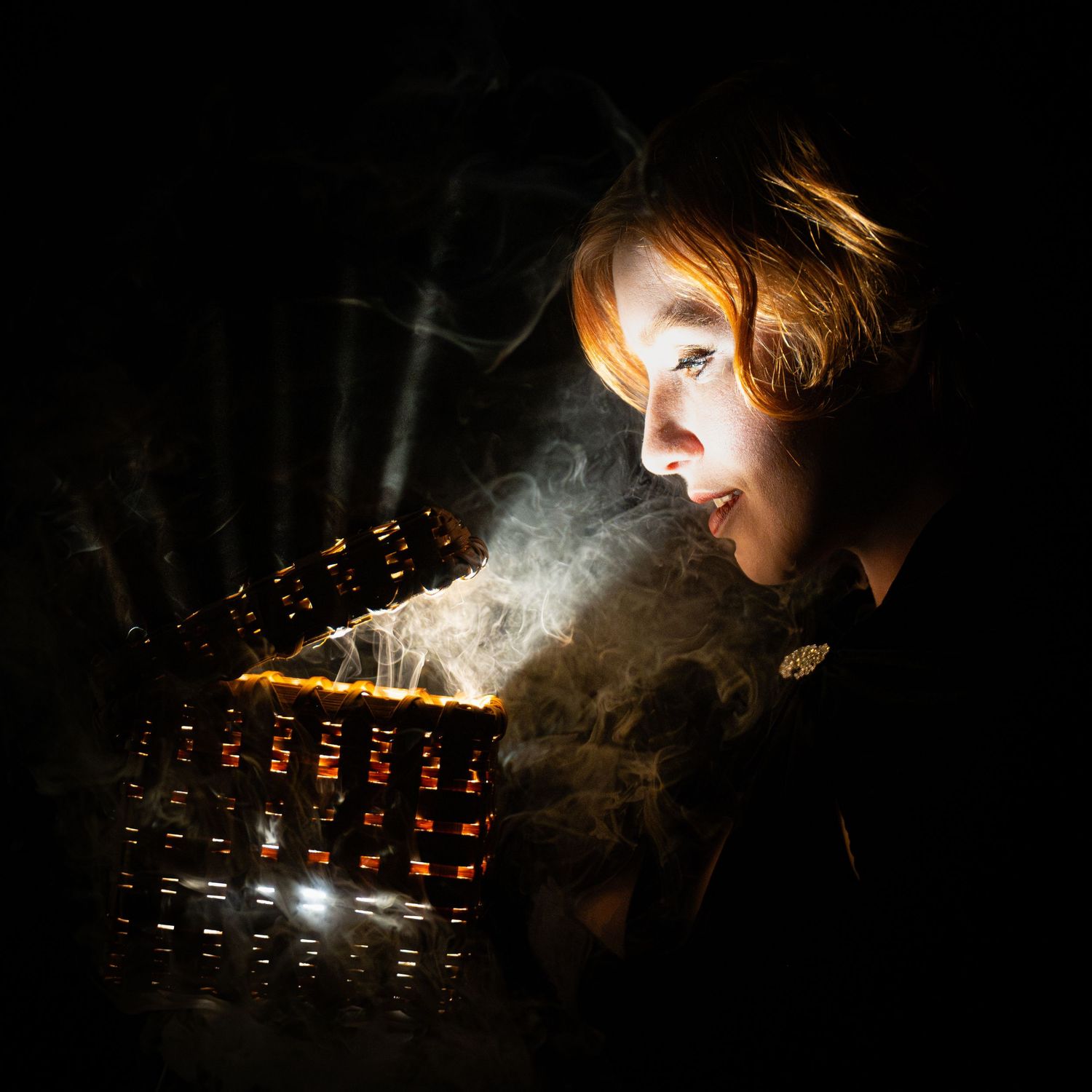 Dark atmospheric photo of smoke illuminated by dim lighting.