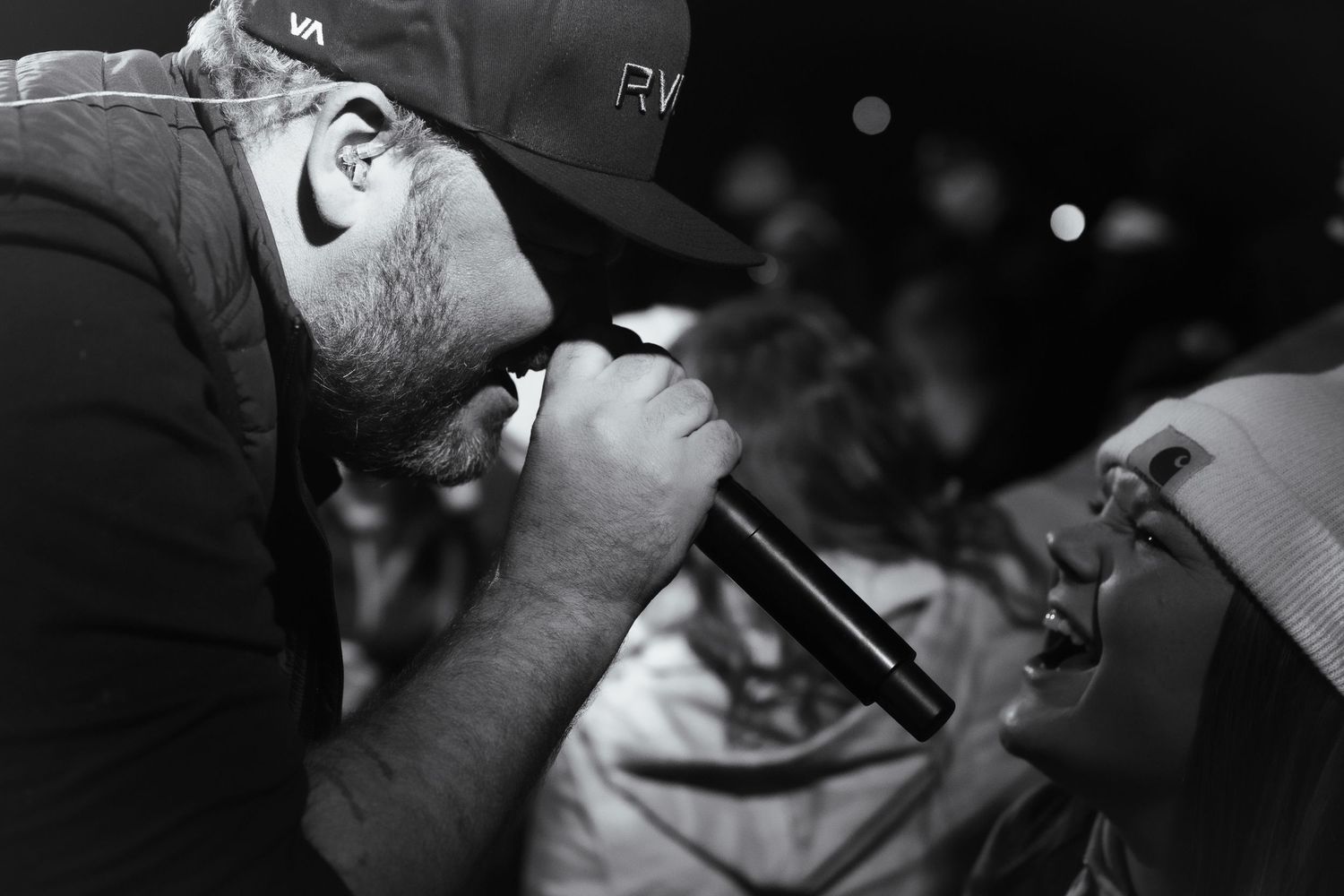 Close-up black and white shots of musicians performing on stage with microphones and instruments. Grand Union Spooks on Spurr