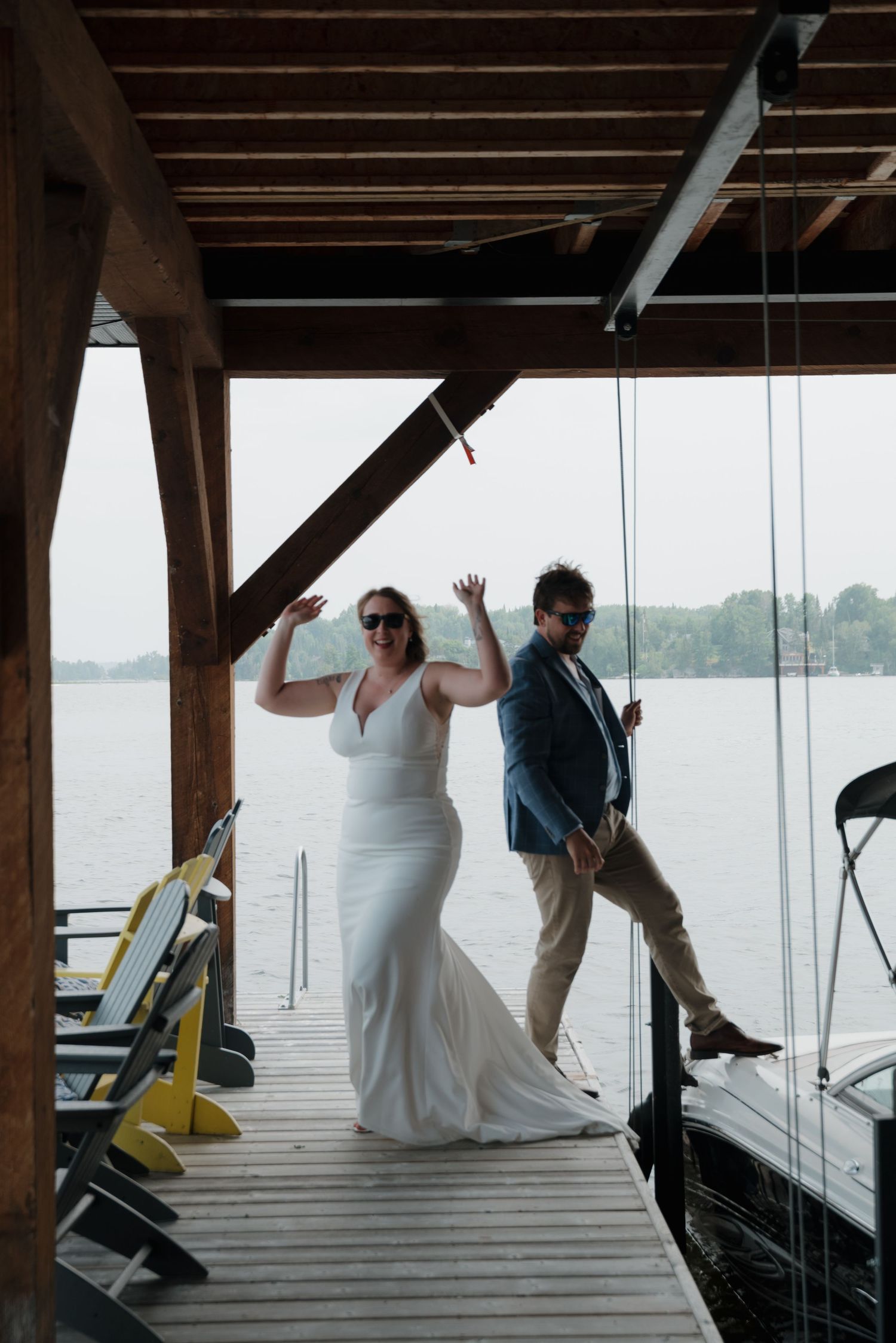 A playful sequence of dance moves captured on a lakeside dock under wooden beams.