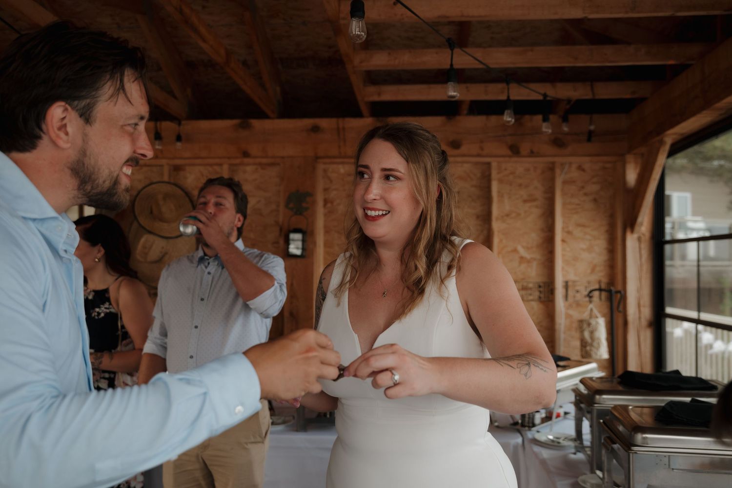 Wedding celebration moments captured inside a rustic wooden barn venue.