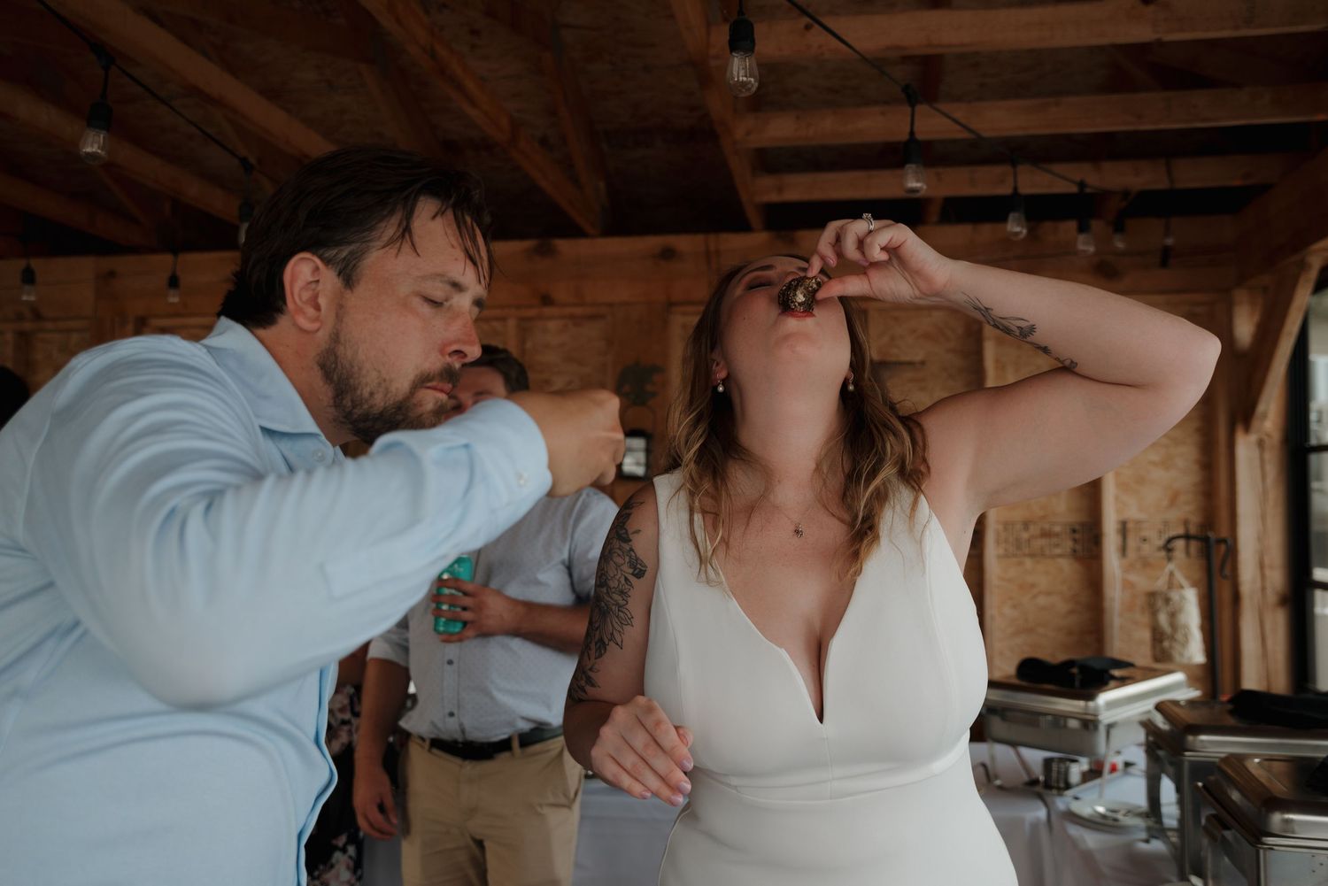Intimate wedding moment captured under a rustic wooden beam ceiling.