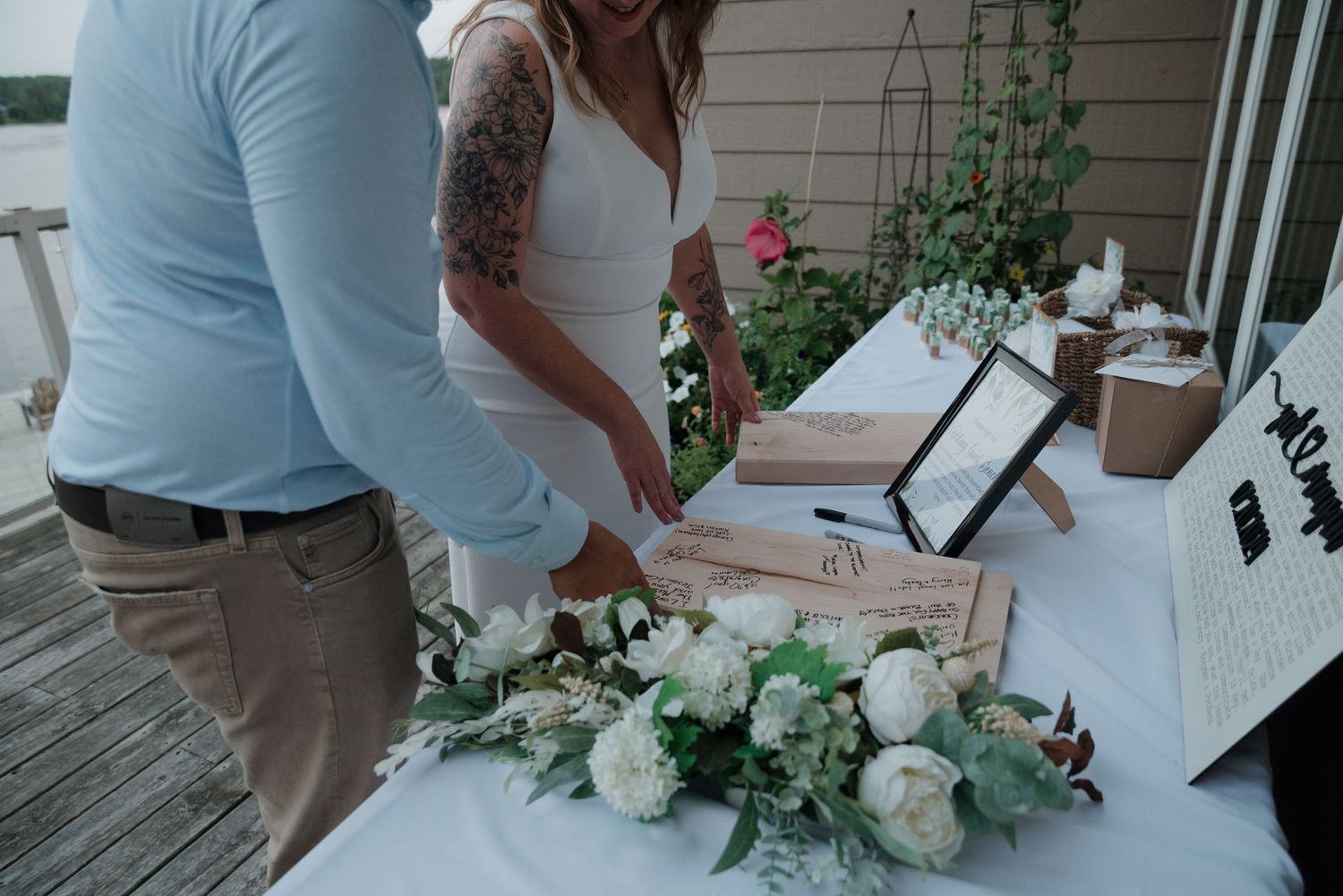 Wedding decor featuring white floral arrangements and greenery against a light background.