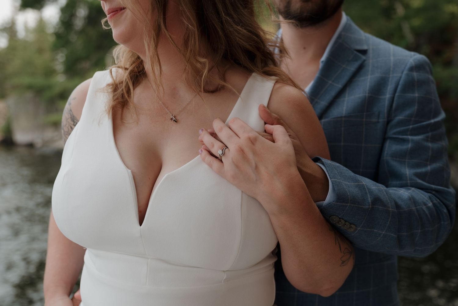 A romantic moment between newlyweds during their wedding photoshoot outdoors.