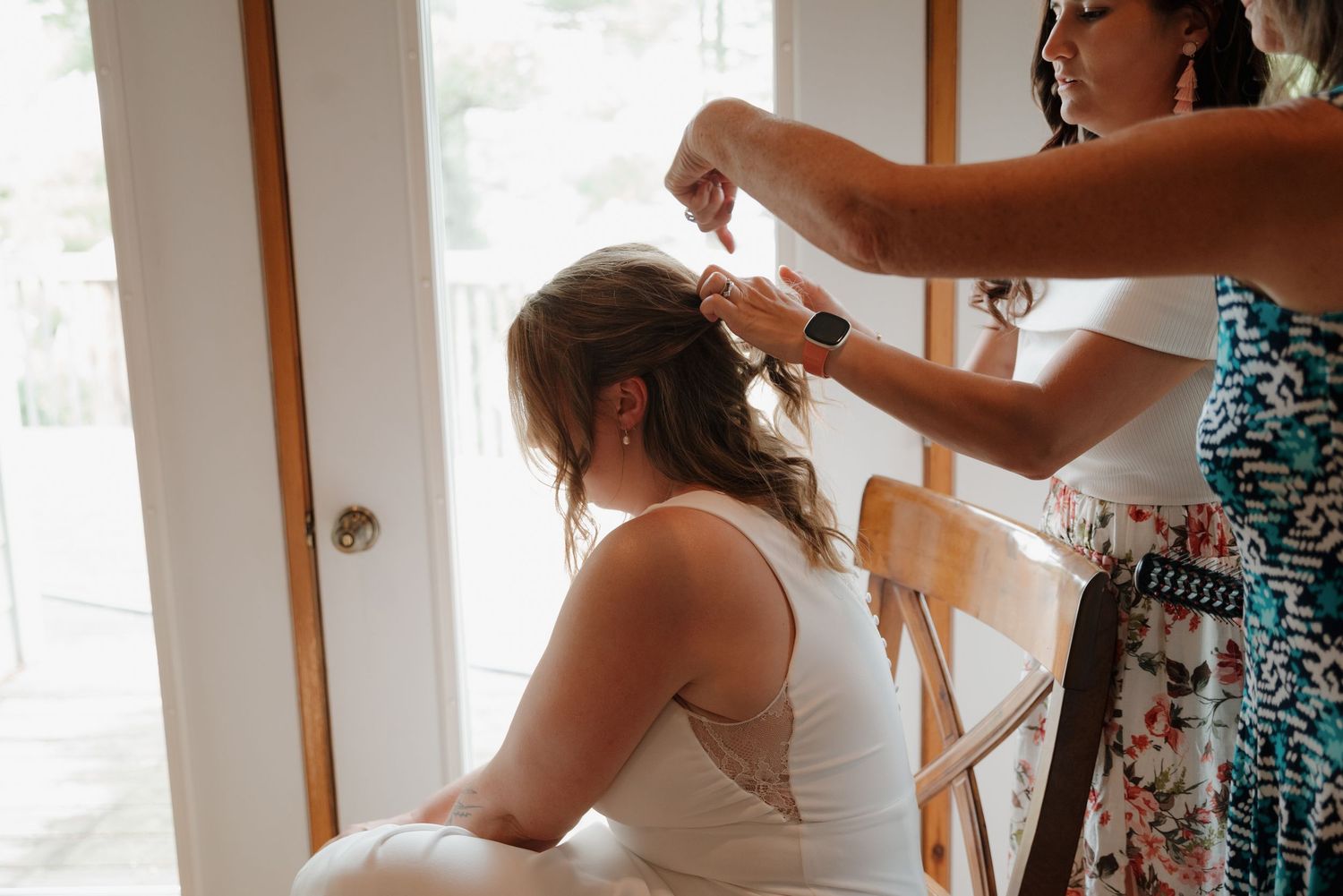 Getting ready scene in bright indoor room with natural light streaming through windows.