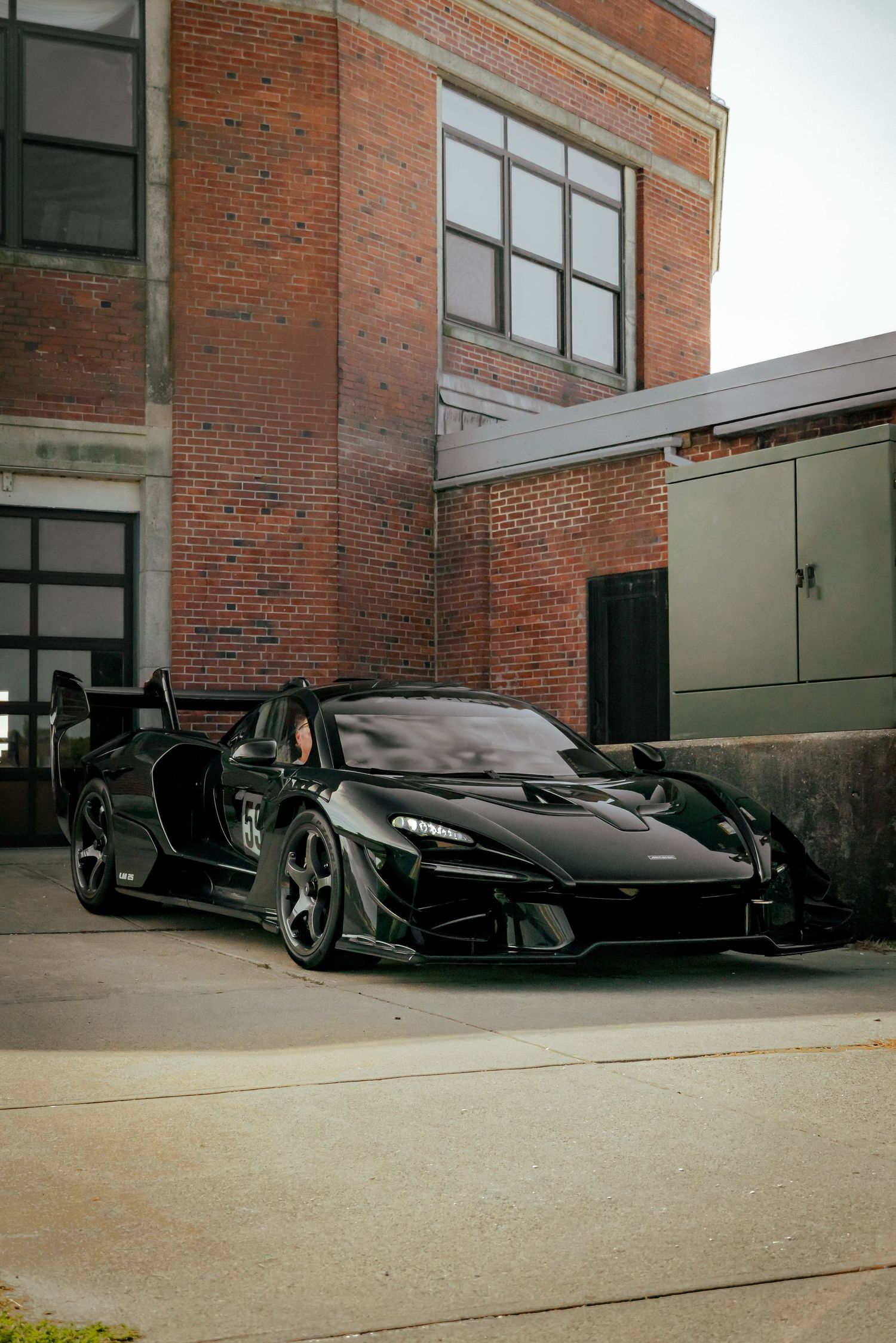 Mclaren Senna parked against a brick building for Audrain Concours Motor Week