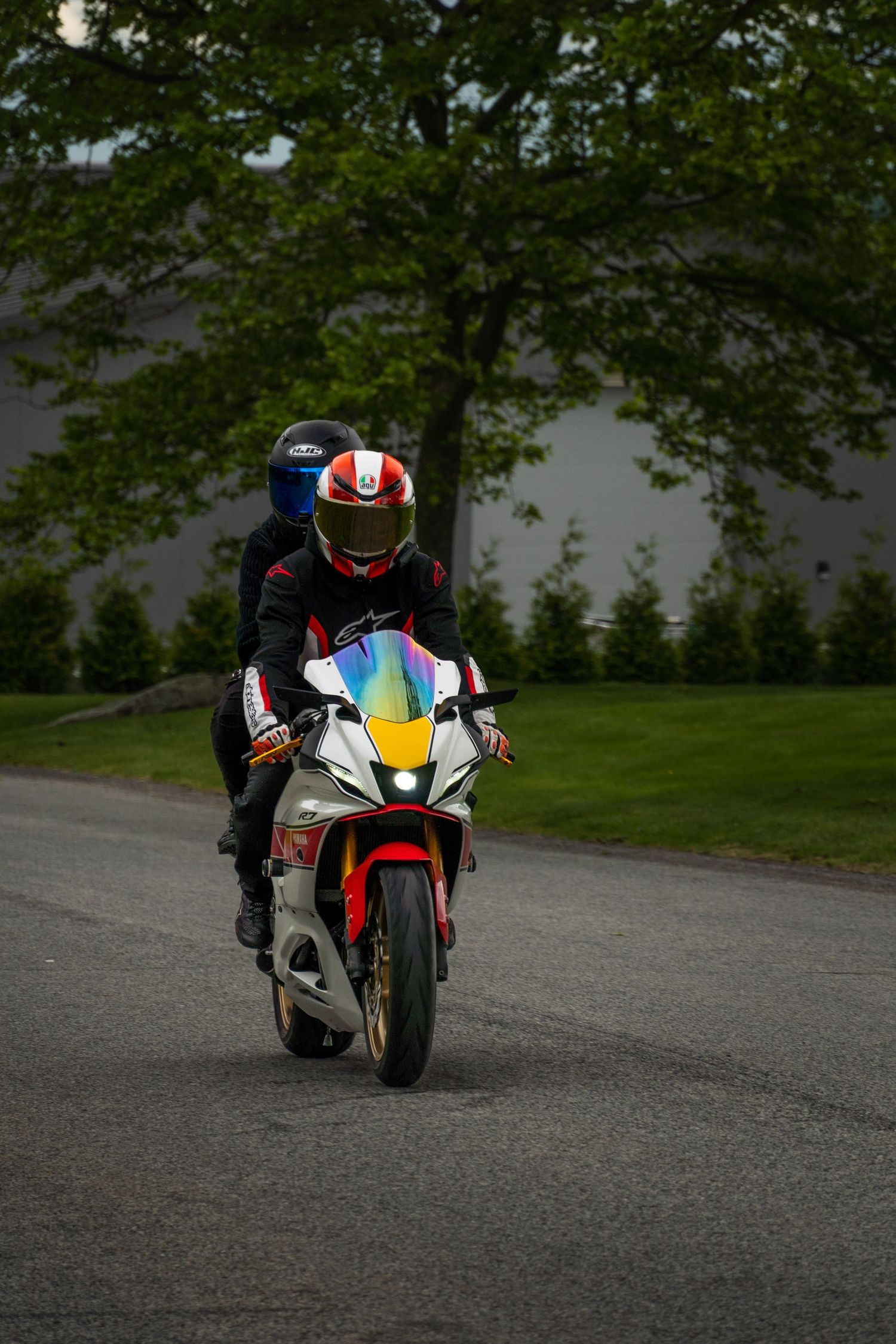 White motorcycle cruising with backpack