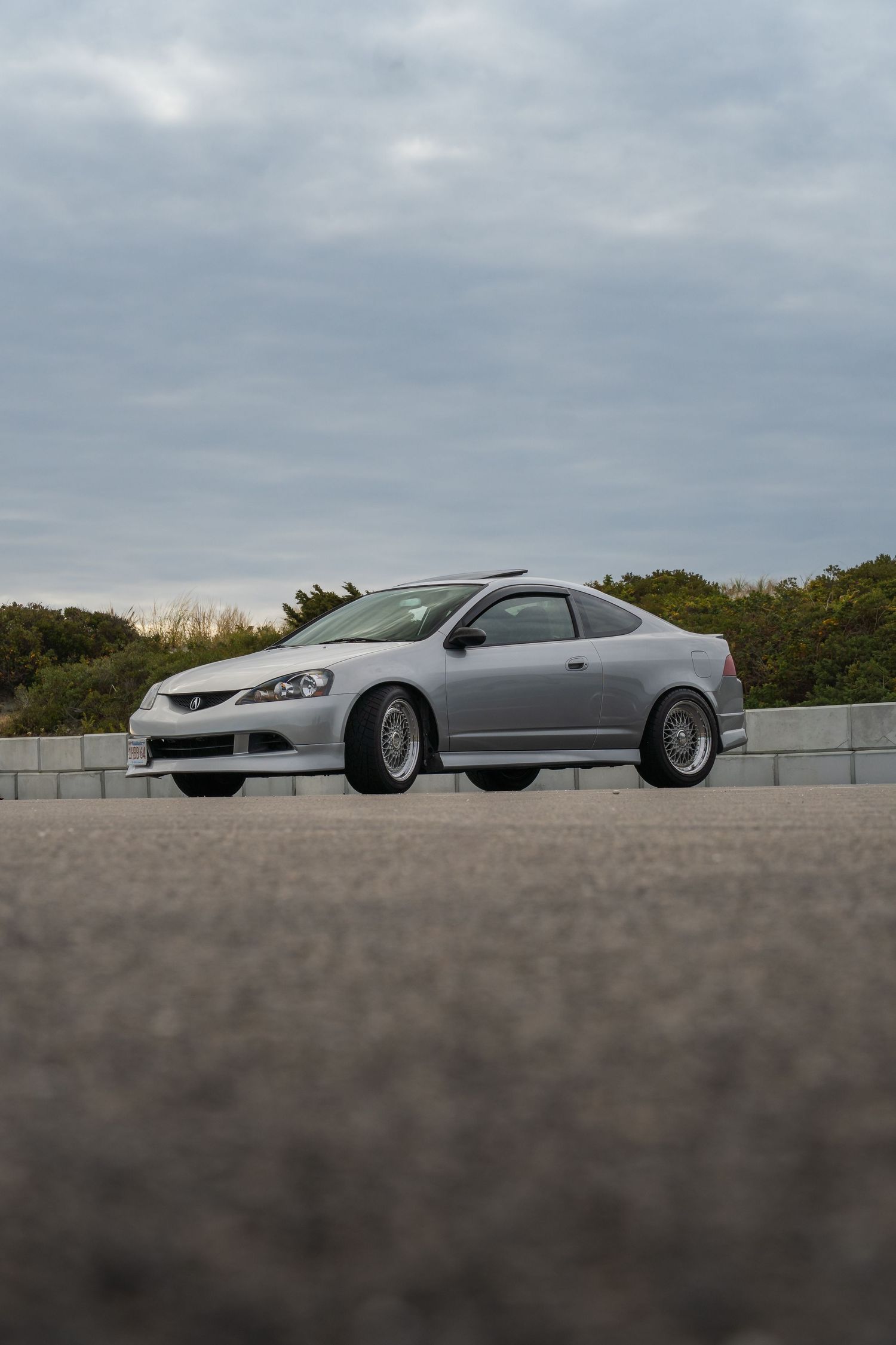Silver Acura Rsx on a cloudy day