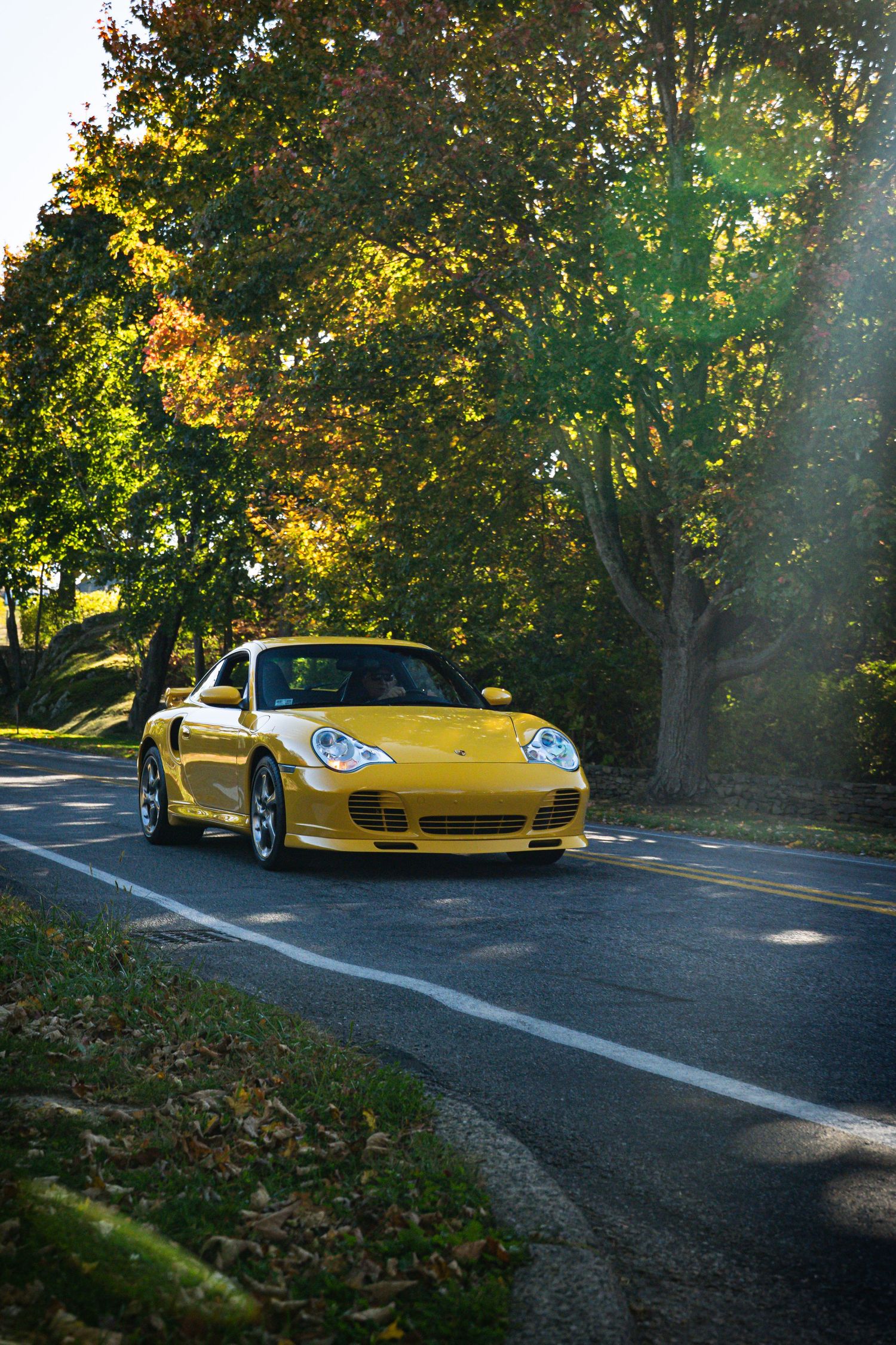 Porsche driving on the back roads in Newport, RI in the summer time