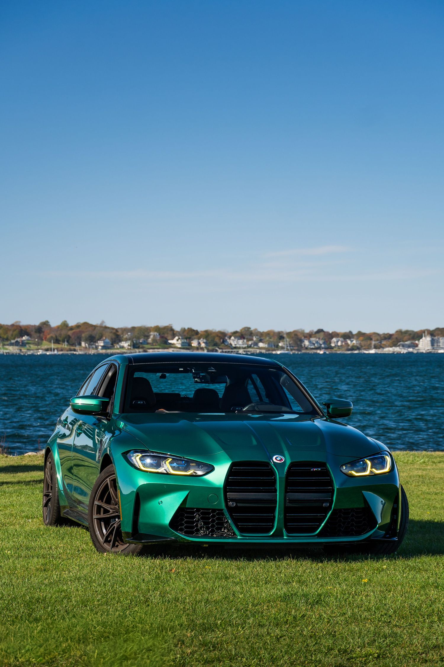 BMW parked on grass in front of the bay in Newport,RI for Cars and Coffee hosted by Audrain Auto Musuem