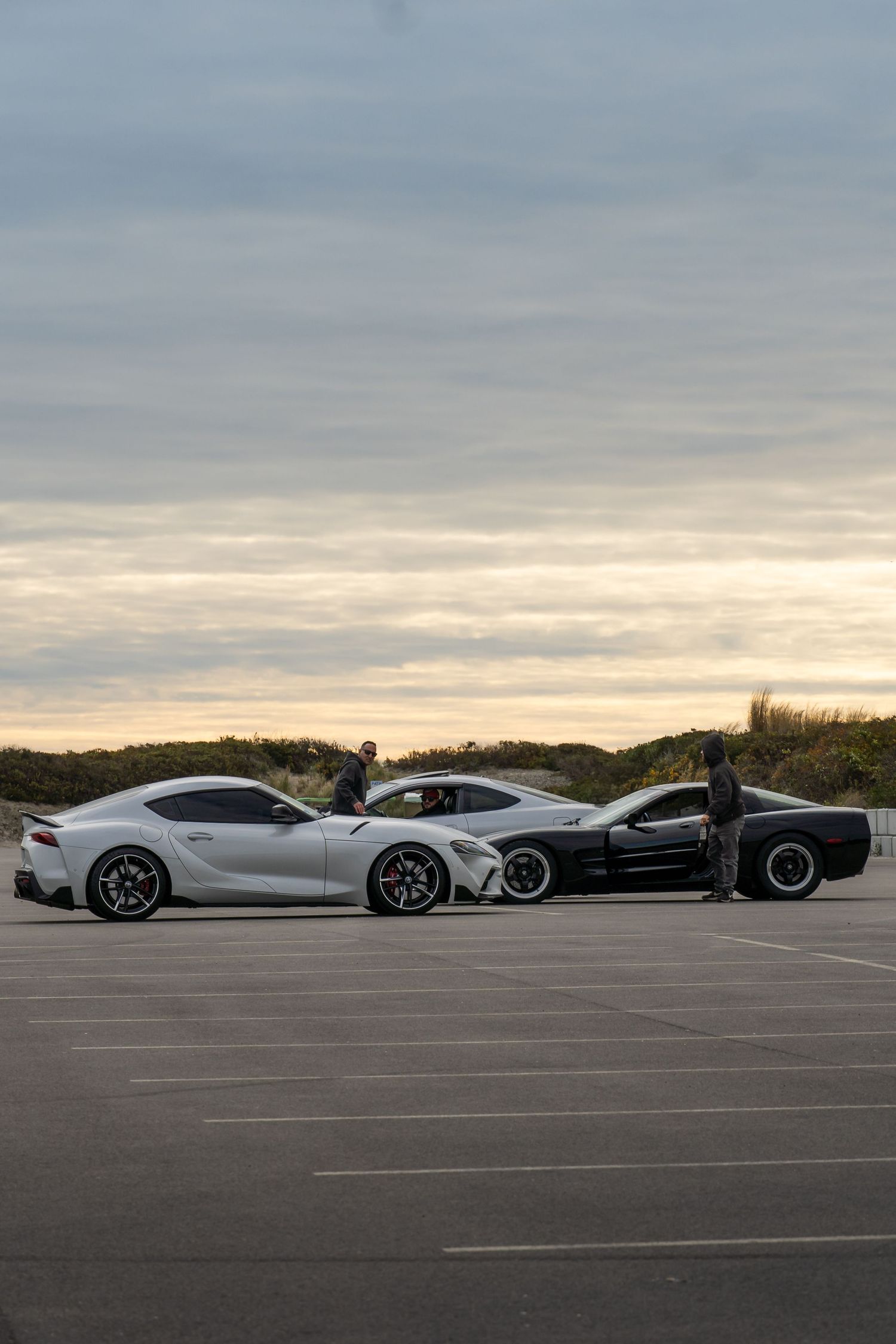 Toyota Supra GR, C5 Chevrolet Corvette and Acura Rsx parked together after a cars and coffee event