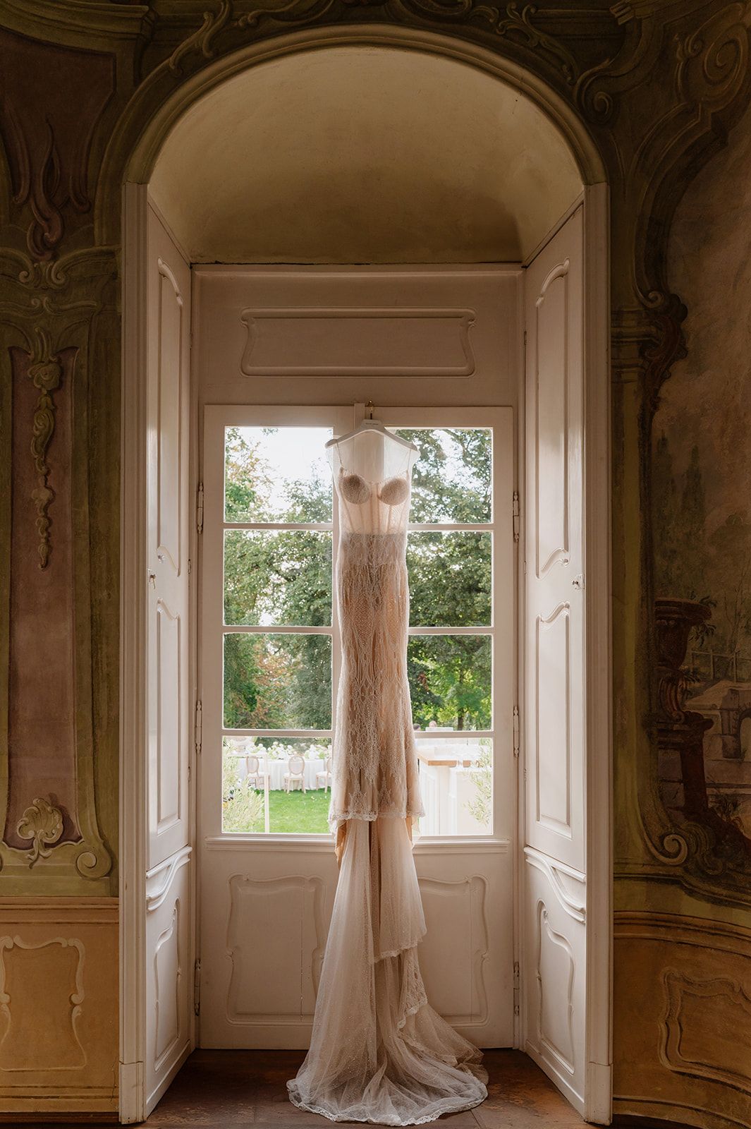 Elegant white-walled room with arched doorways and windows letting in natural light.