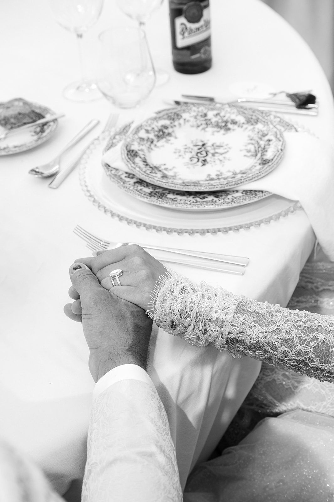 Close-up of delicate lace details and place settings at an elegant wedding table.