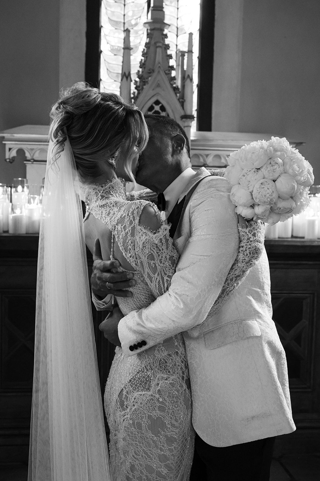Black and white wedding photos showing intimate moments in a church setting.