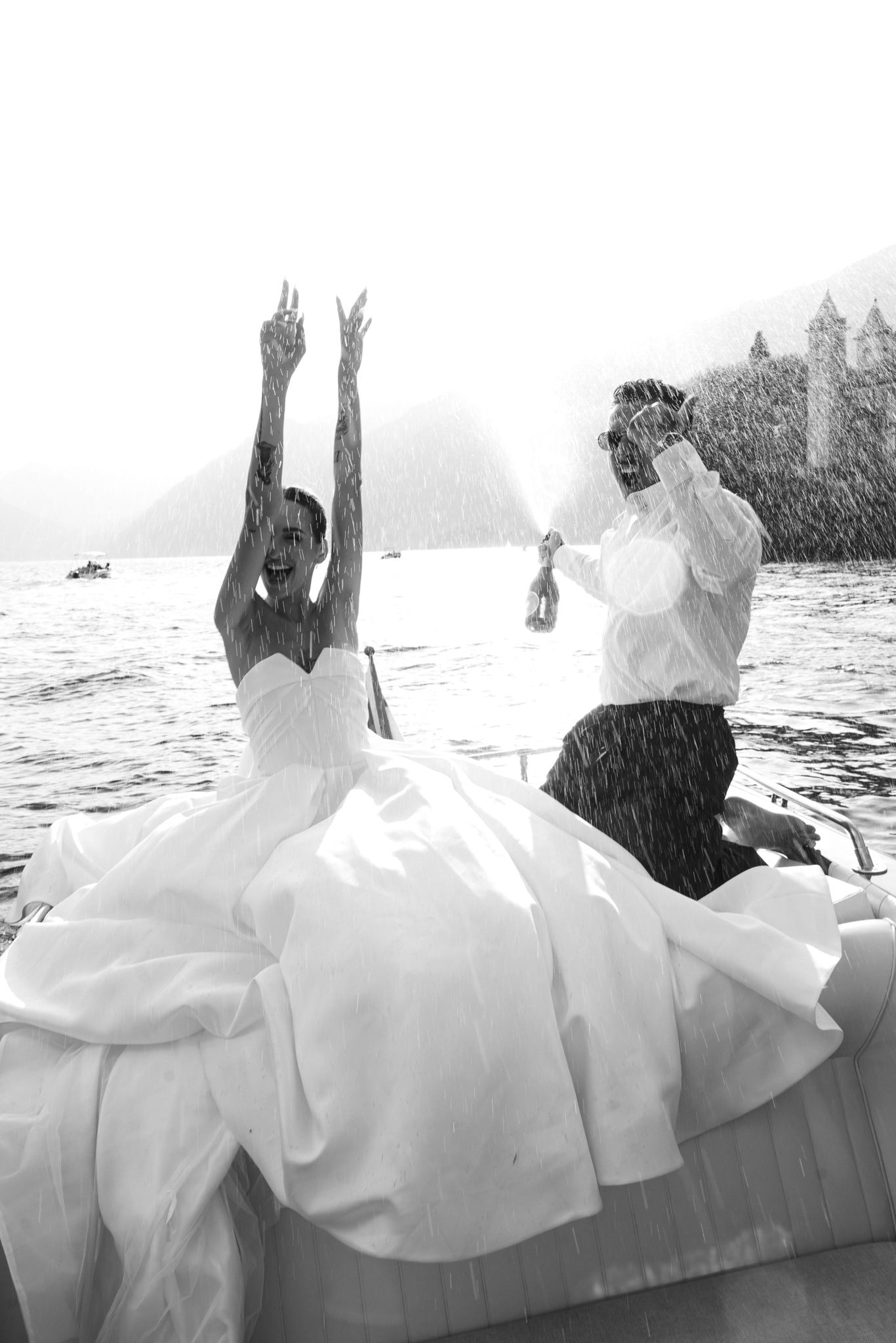 A sequence of black and white photos showing a couple falling backwards into water while wearing formal attire.