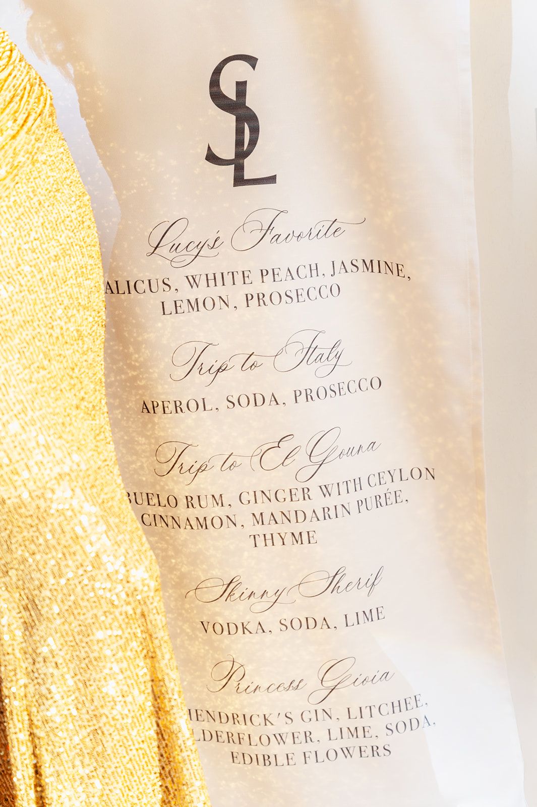 Elegant wedding cocktail menu cards with gold accents and calligraphy text.