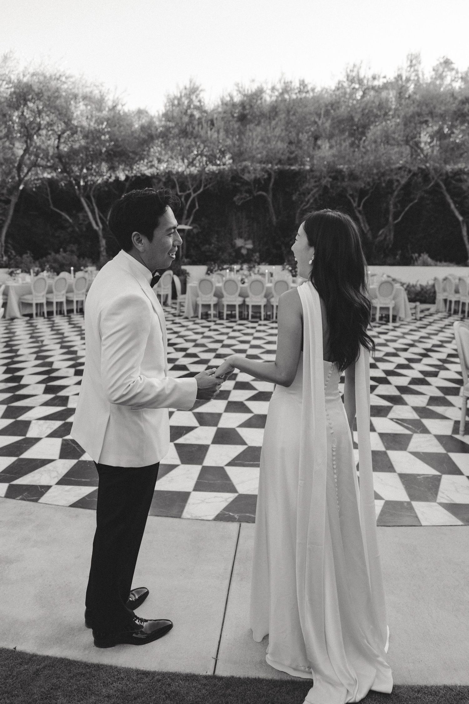Wedding photoshoot on a dramatic black and white checkered outdoor patio.