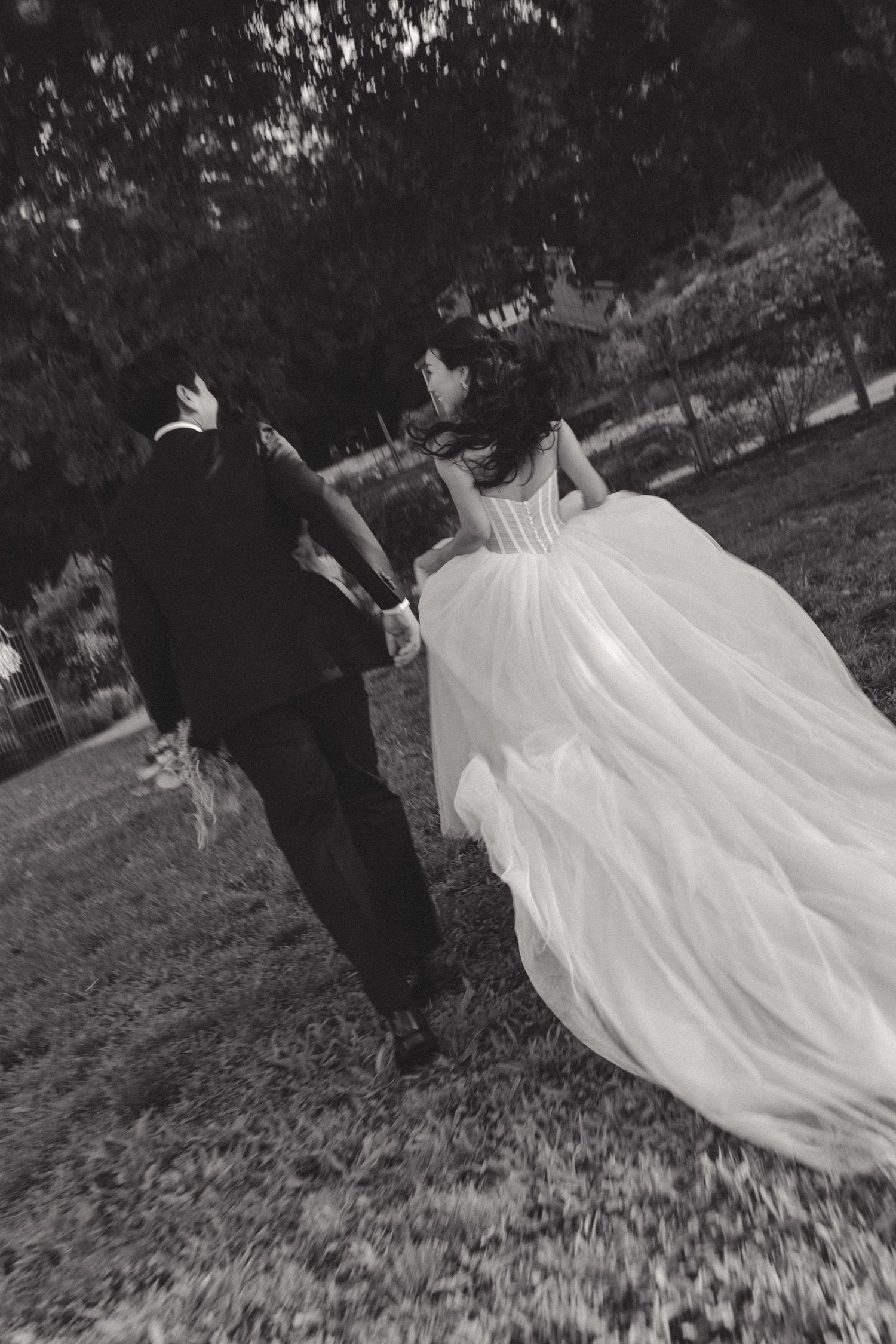 Black and white photos of couple spinning and dancing with flowing white dress.