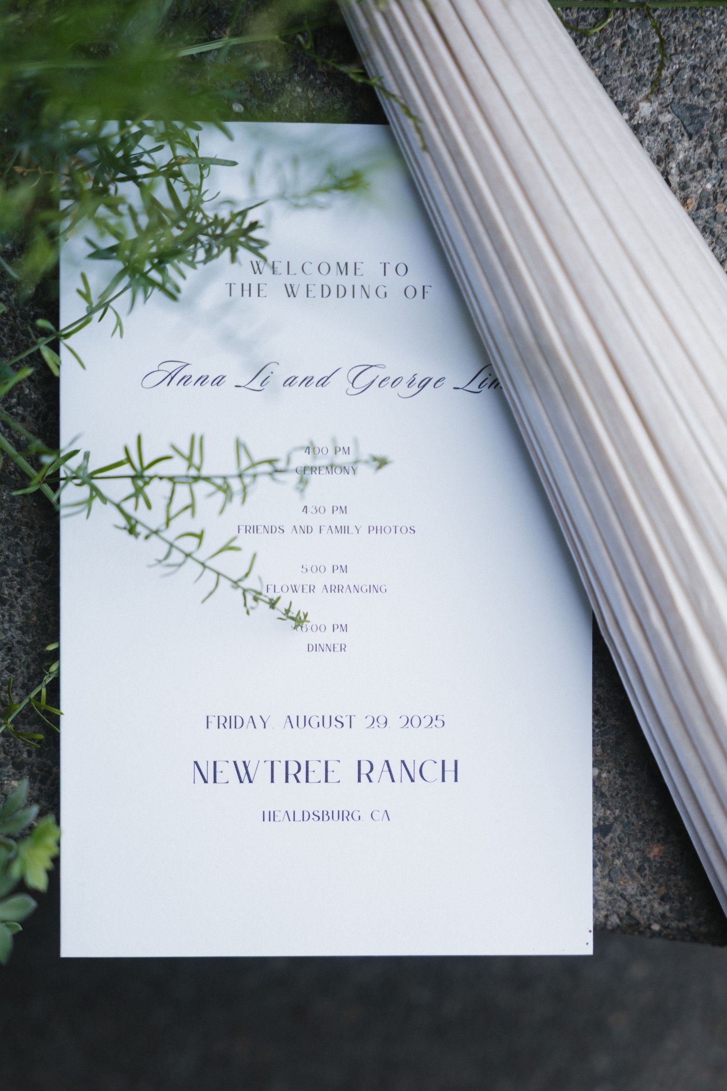 Elegant wedding invitation with floral details and column architecture in natural lighting.