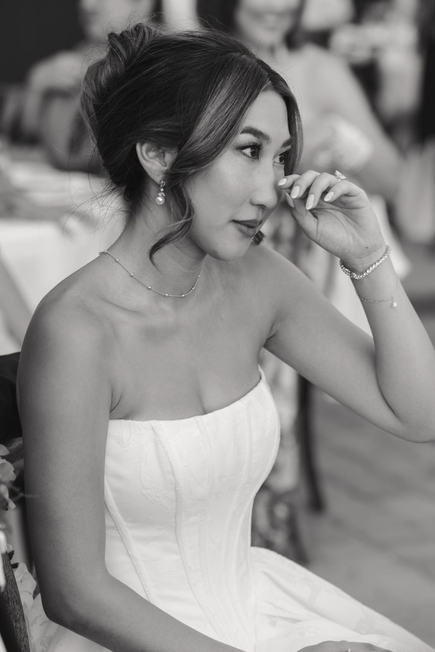 Black and white photo series showing close-up details of a bride in a strapless wedding dress.