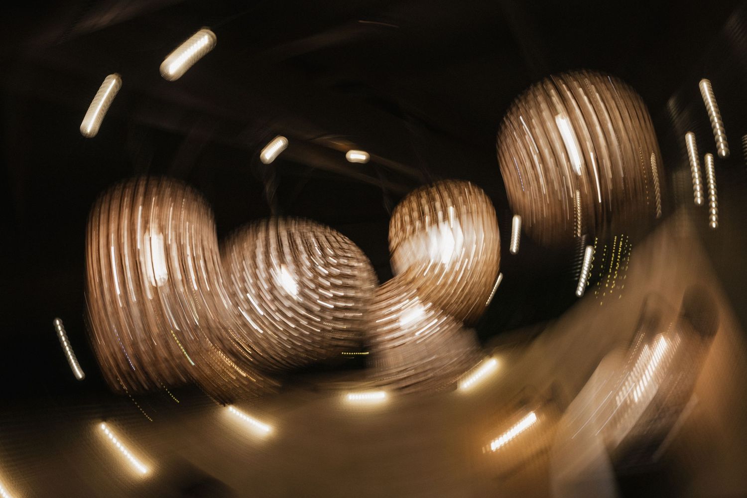 Paper lanterns create ambient lighting at an evening wedding reception.
