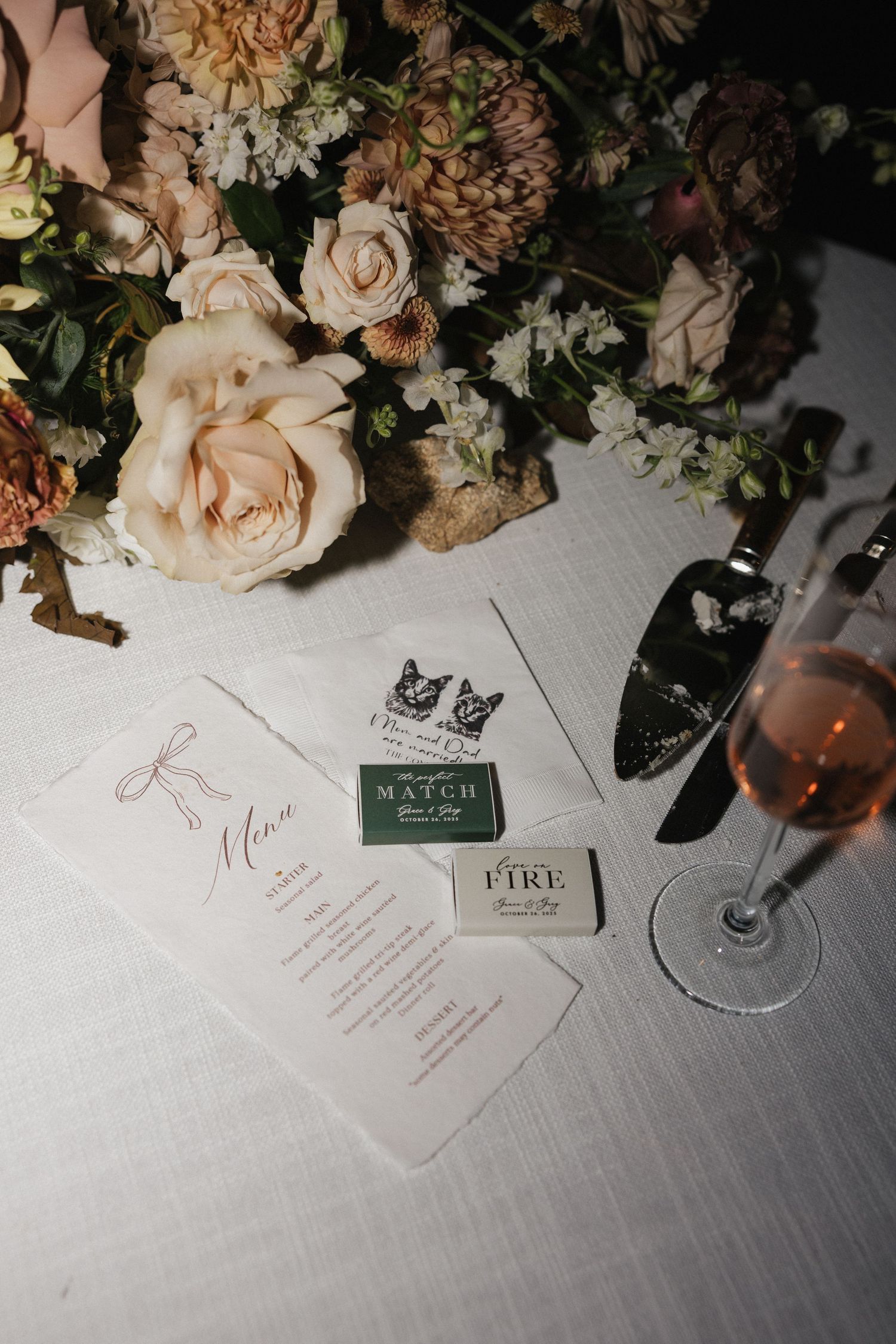 Wedding reception table details with floral arrangements and menu cards.