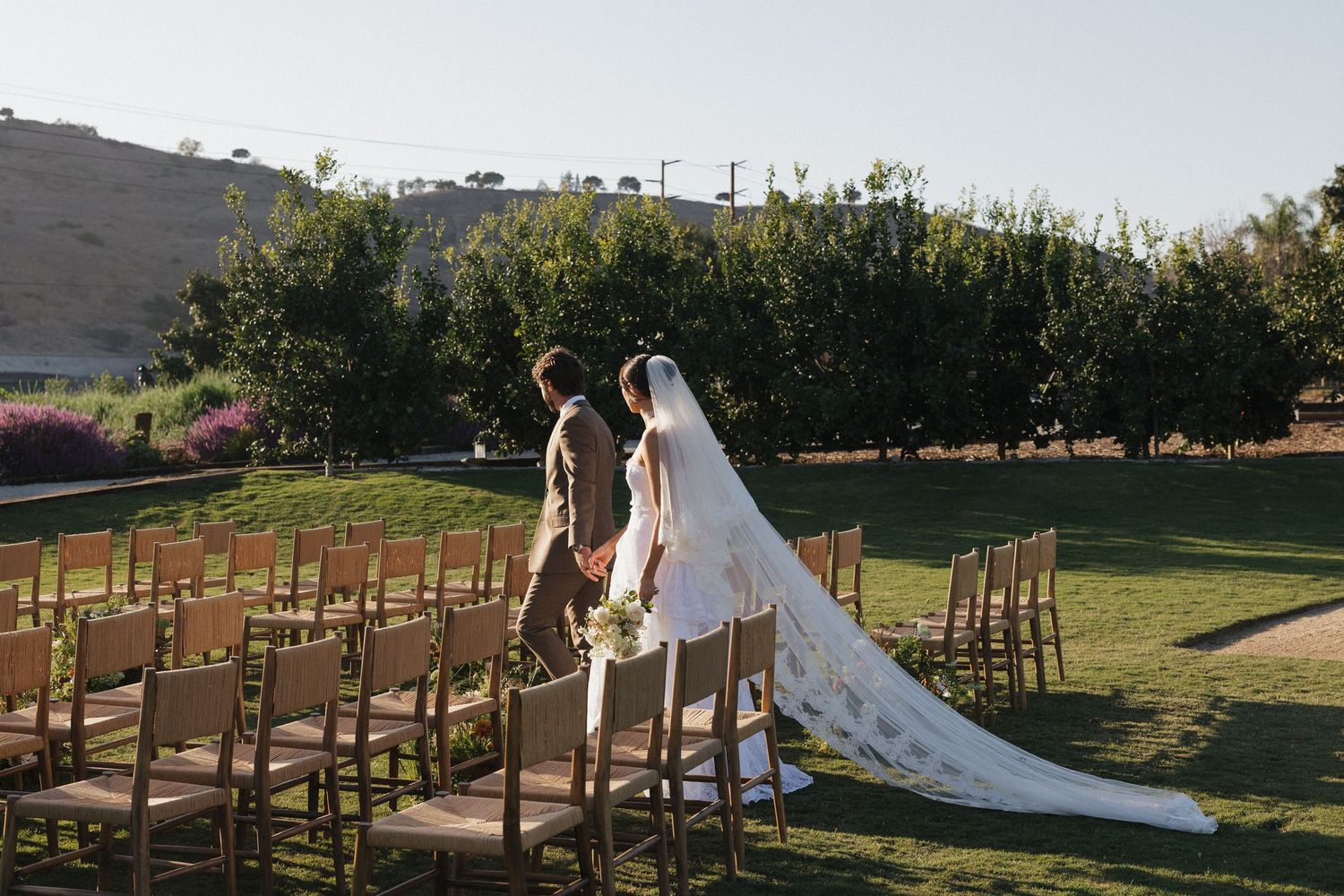 A series of outdoor wedding ceremony photos showing wooden chairs and floral arrangements in a garden setting at sunset.