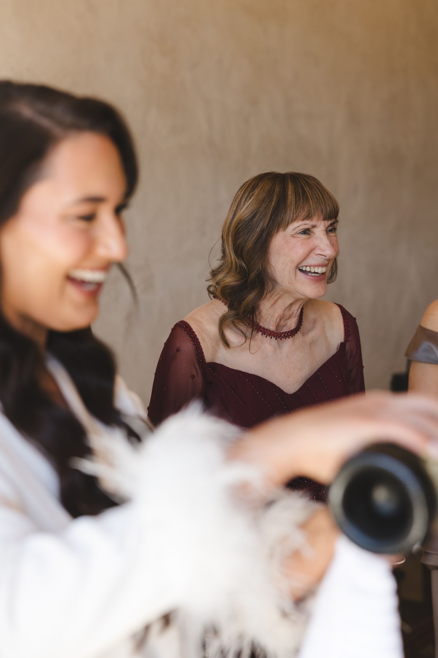 Joyful laughter during champagne celebration in getting ready room.