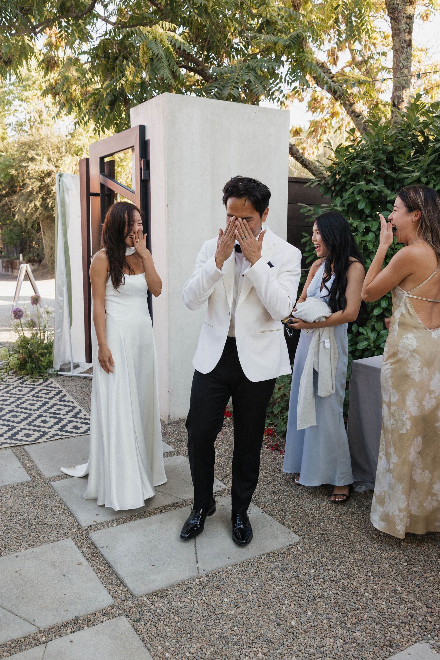Wedding party members peek around a white wall in a playful photo sequence.