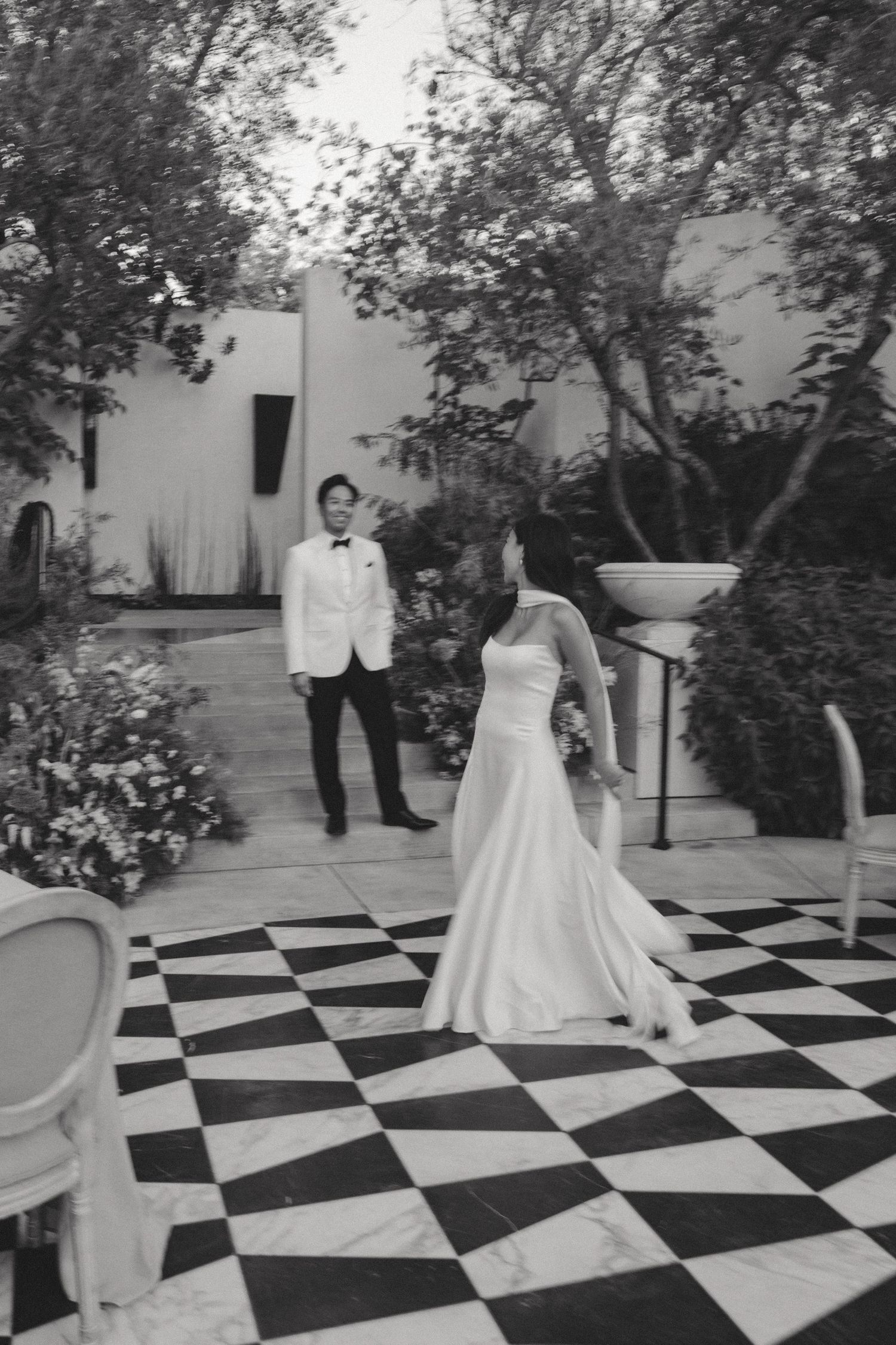 A sequence of dancing moments captured on a black and white checkered dance floor at an outdoor wedding reception.
