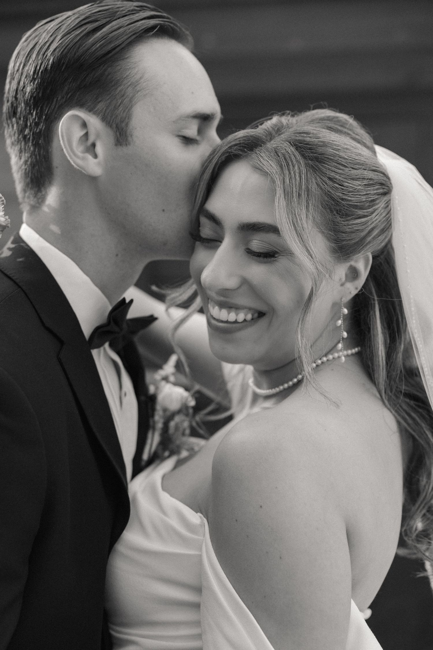 Black and white intimate wedding portraits showing tender romantic moments between newlyweds.