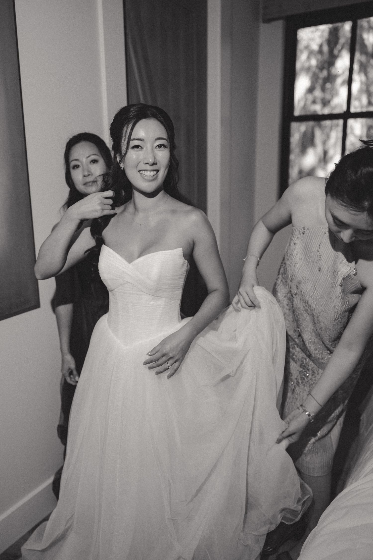 A series of photos showing the details of a white wedding dress being fitted and adjusted.