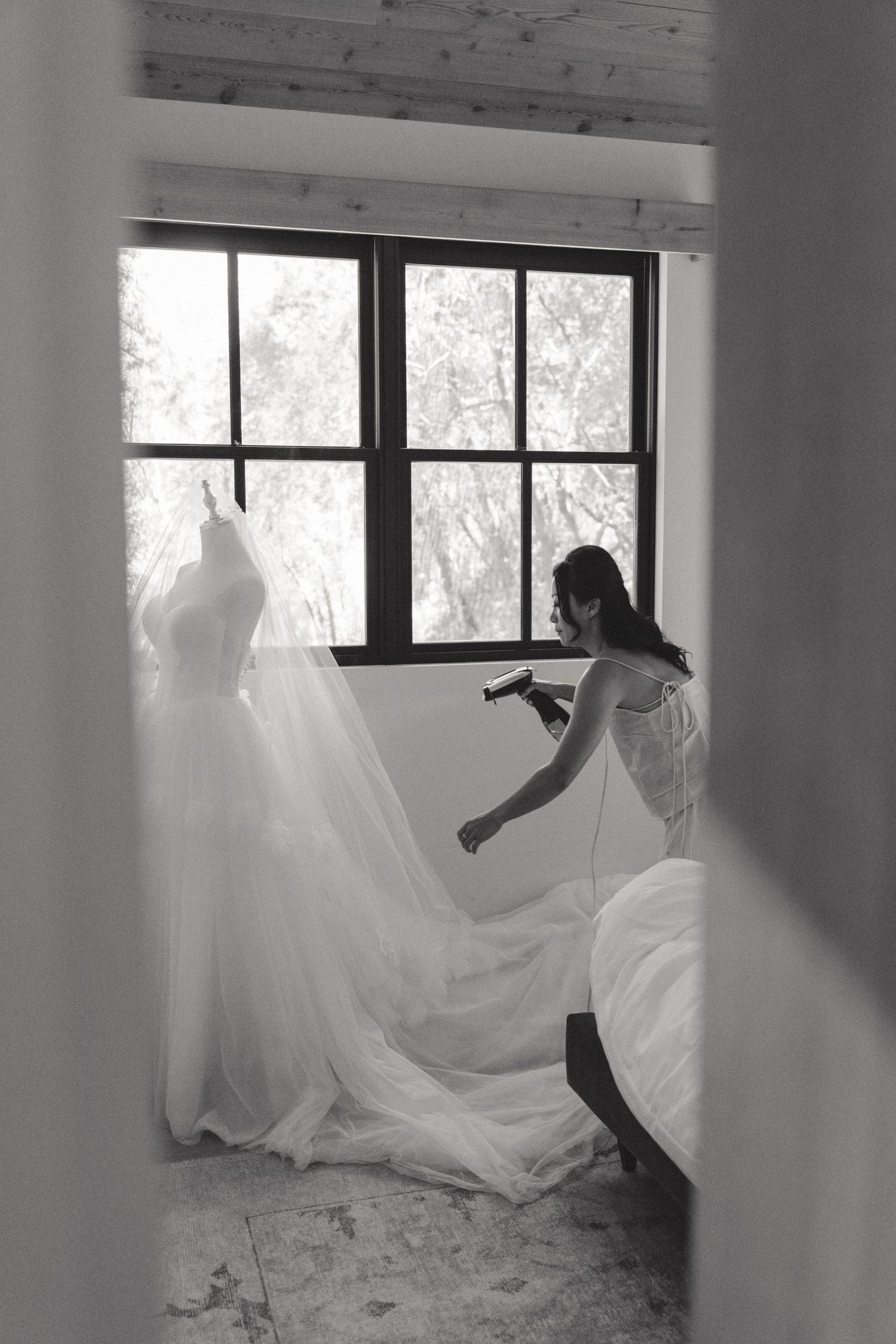 Ethereal black and white photo series showing flowing white fabric against a window in an artistic composition.