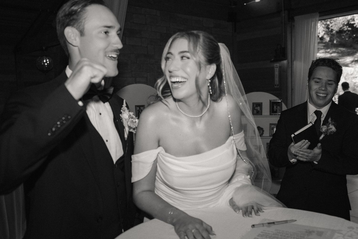 Black and white candid reception photos showing joyful dancing and celebration.