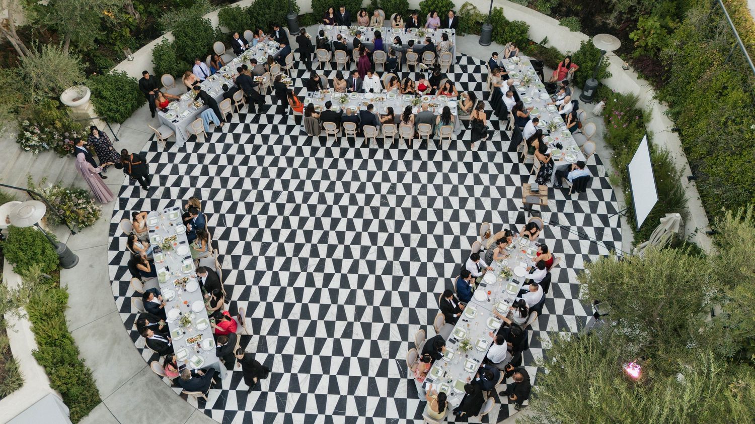 Aerial view of wedding ceremony setup with black and white checkered pattern.