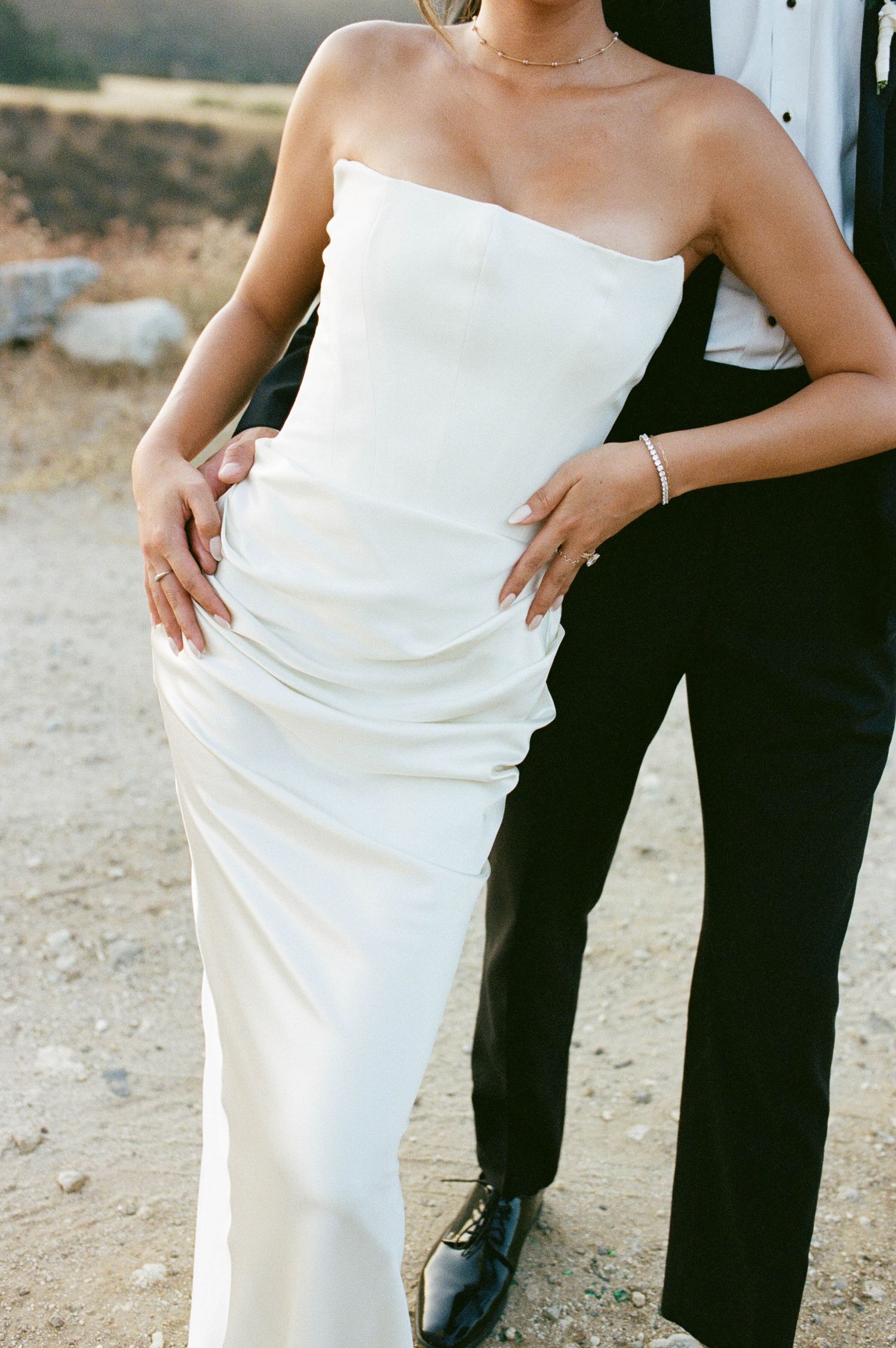 Five cropped photos showing a couple in formal attire, with a white wedding dress and black tuxedo.