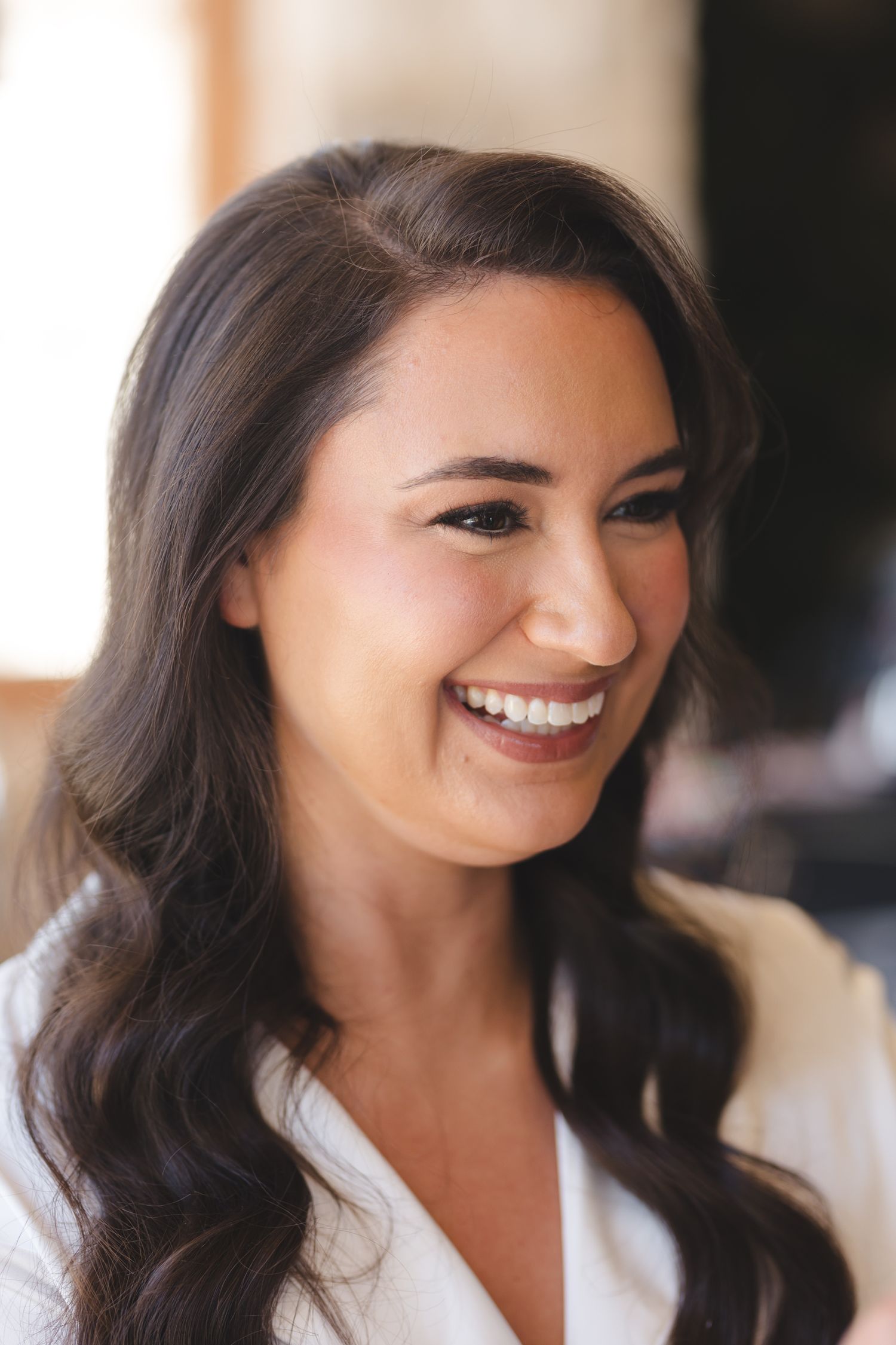 Radiant smile captures joyful wedding day preparation moment.