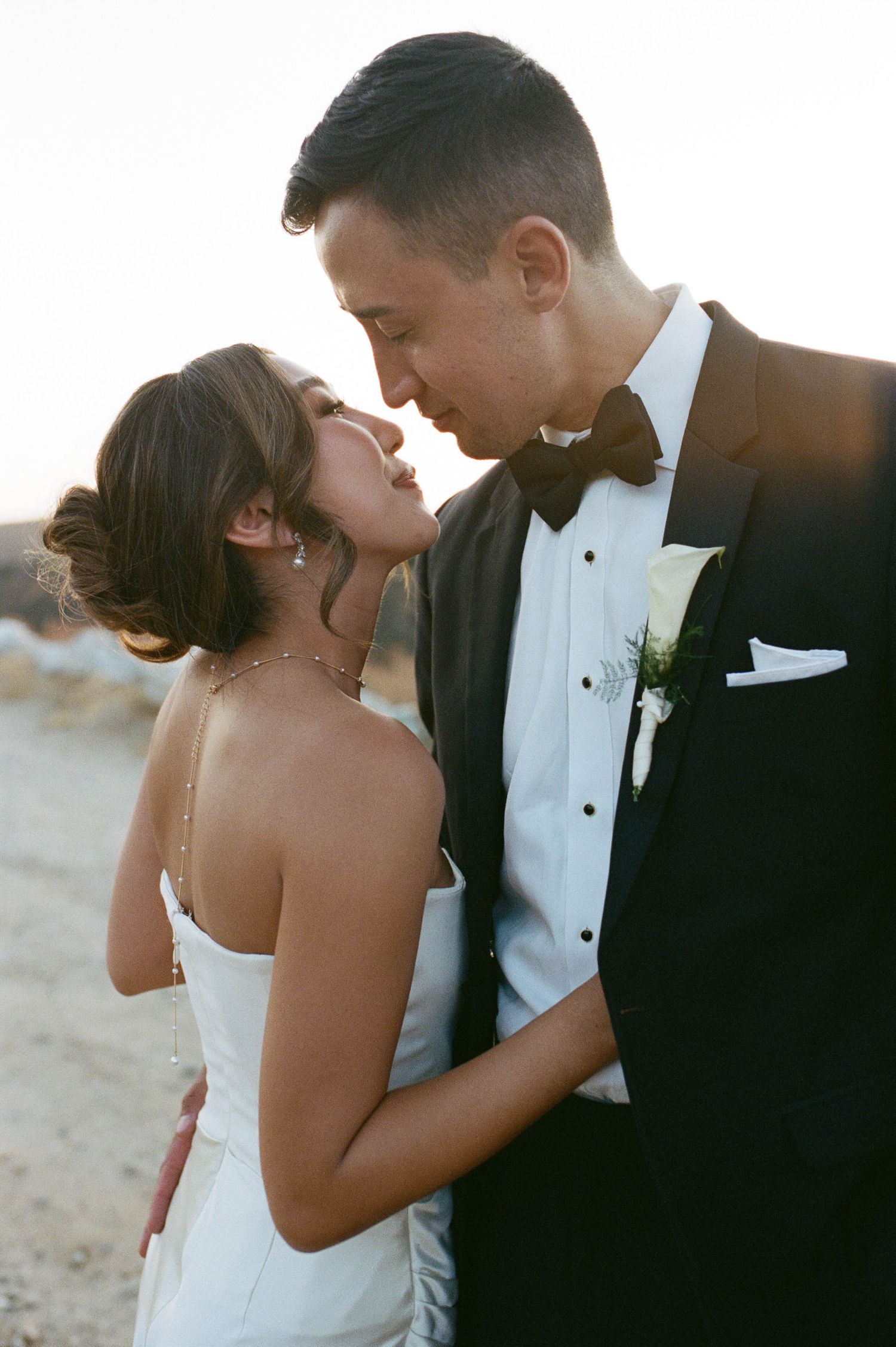 Romantic sunset wedding portraits showing intimate moments between newlyweds.