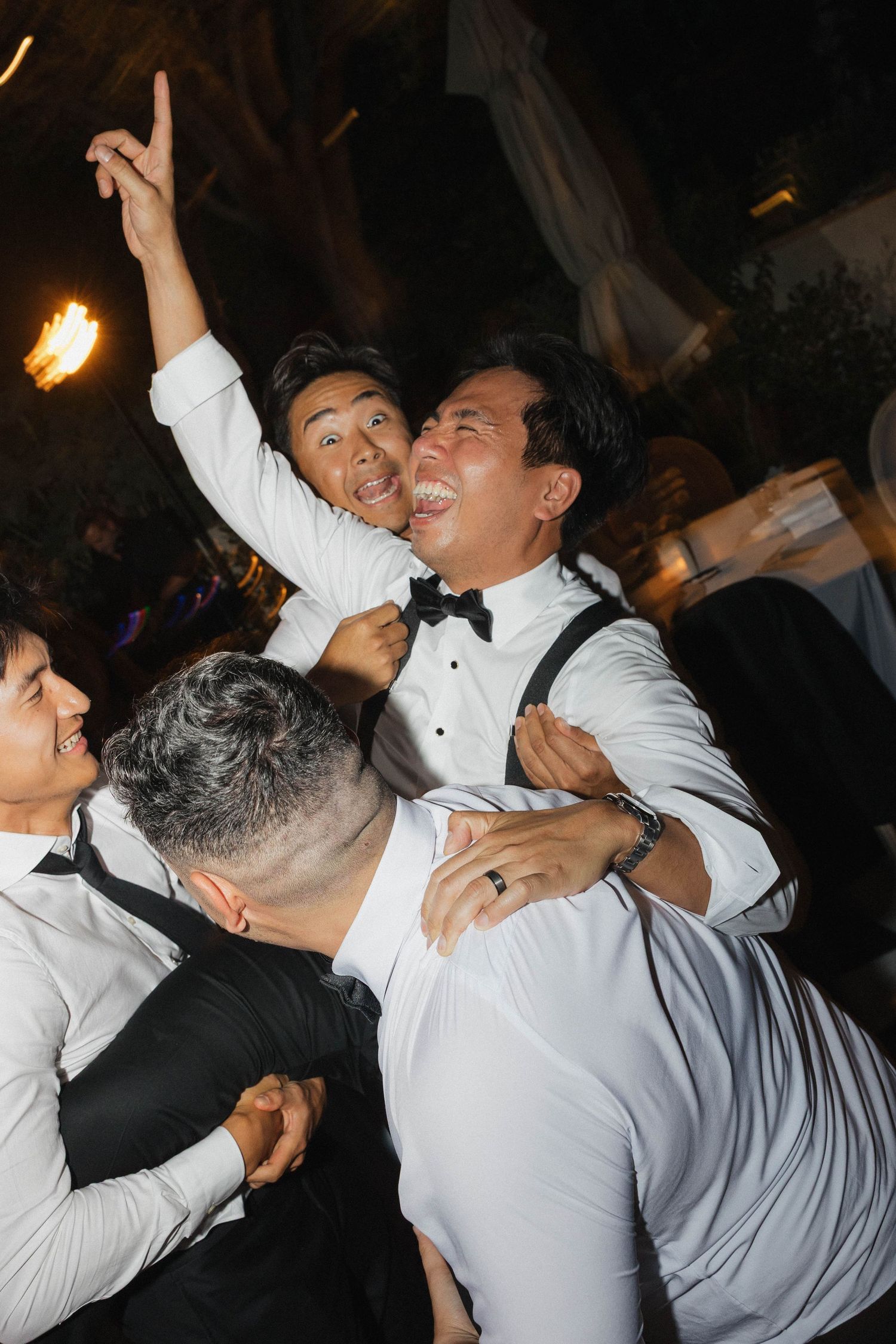 Energetic dance floor moments captured during a wedding reception celebration.