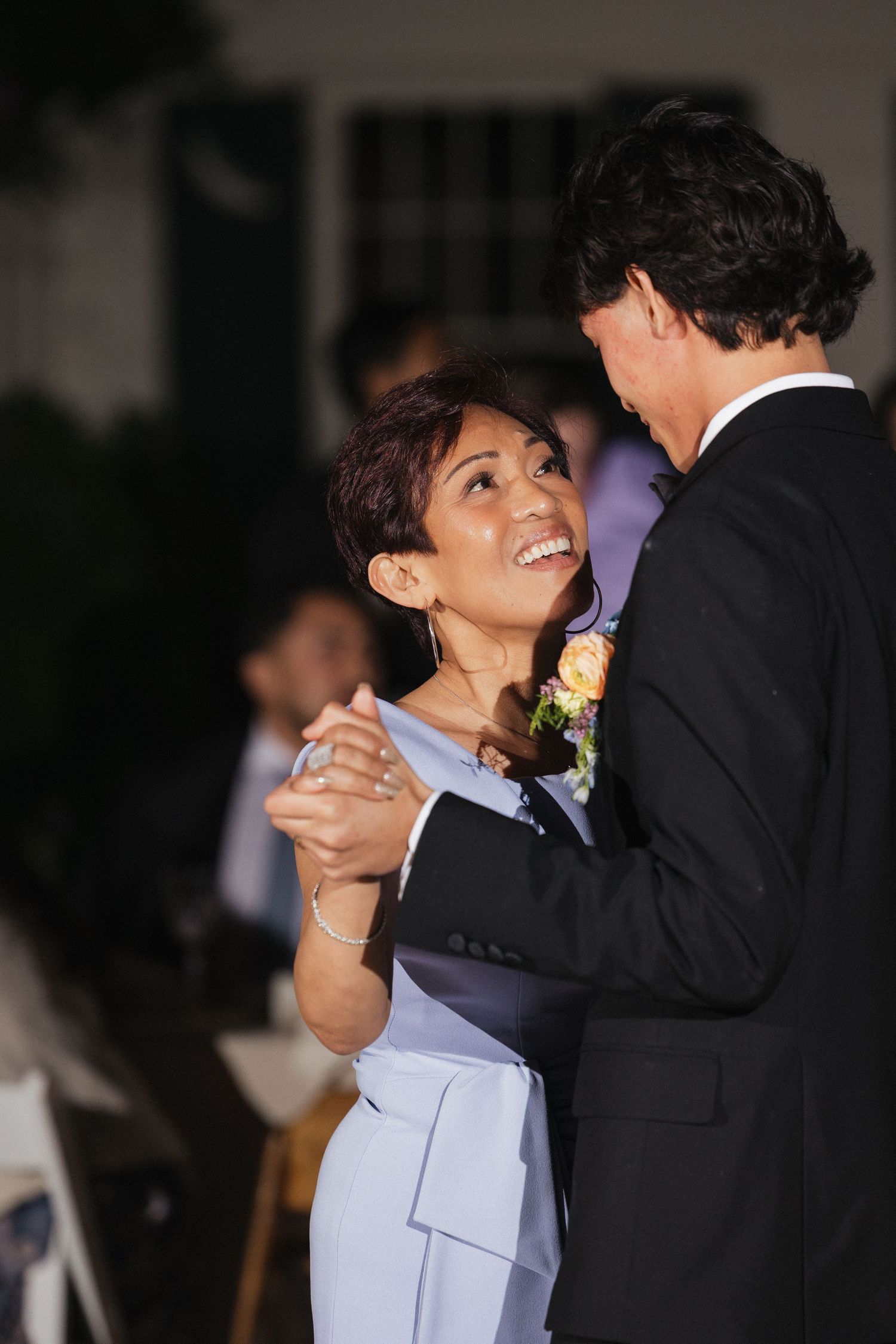 A couple shares a romantic dance moment at their evening wedding reception.