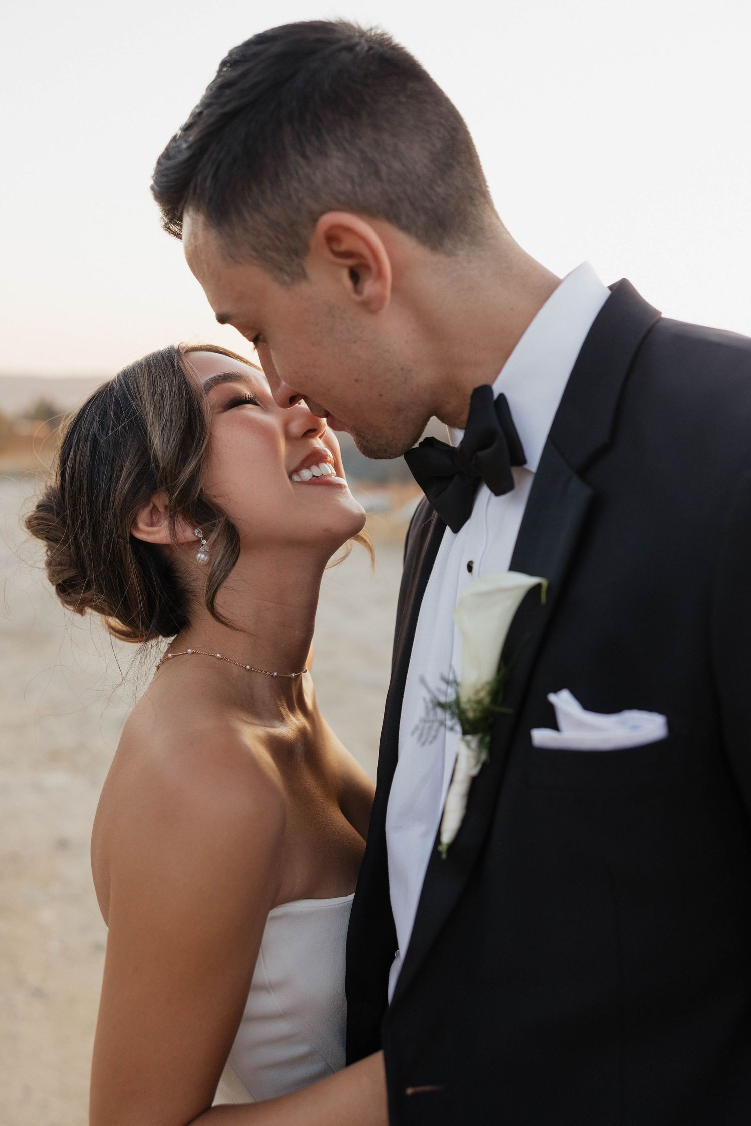Romantic close-up shots of a couple sharing intimate moments during their wedding celebration at sunset.