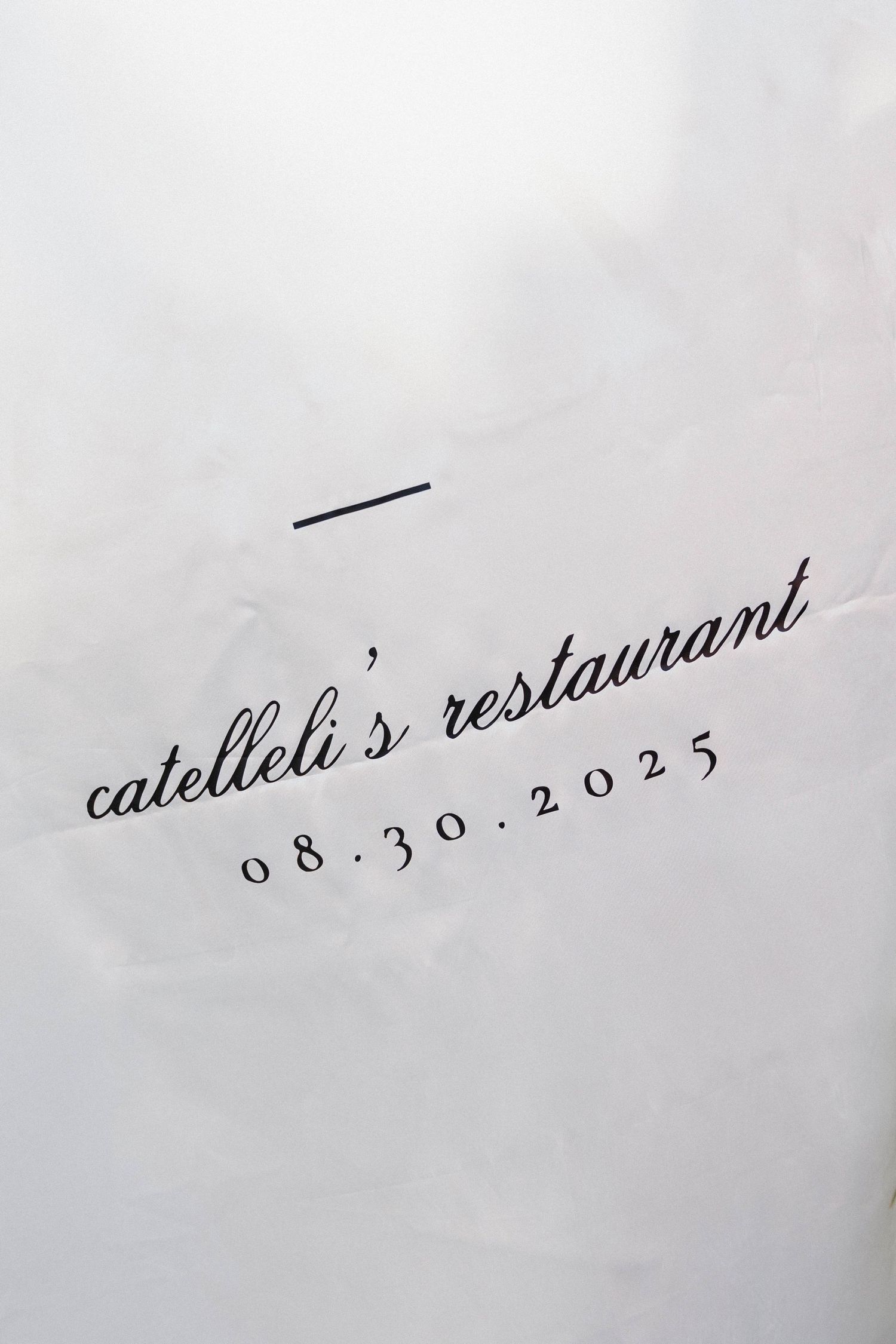 Handwritten text showing 'catelina's restaurant' and a date in cursive on a light background.