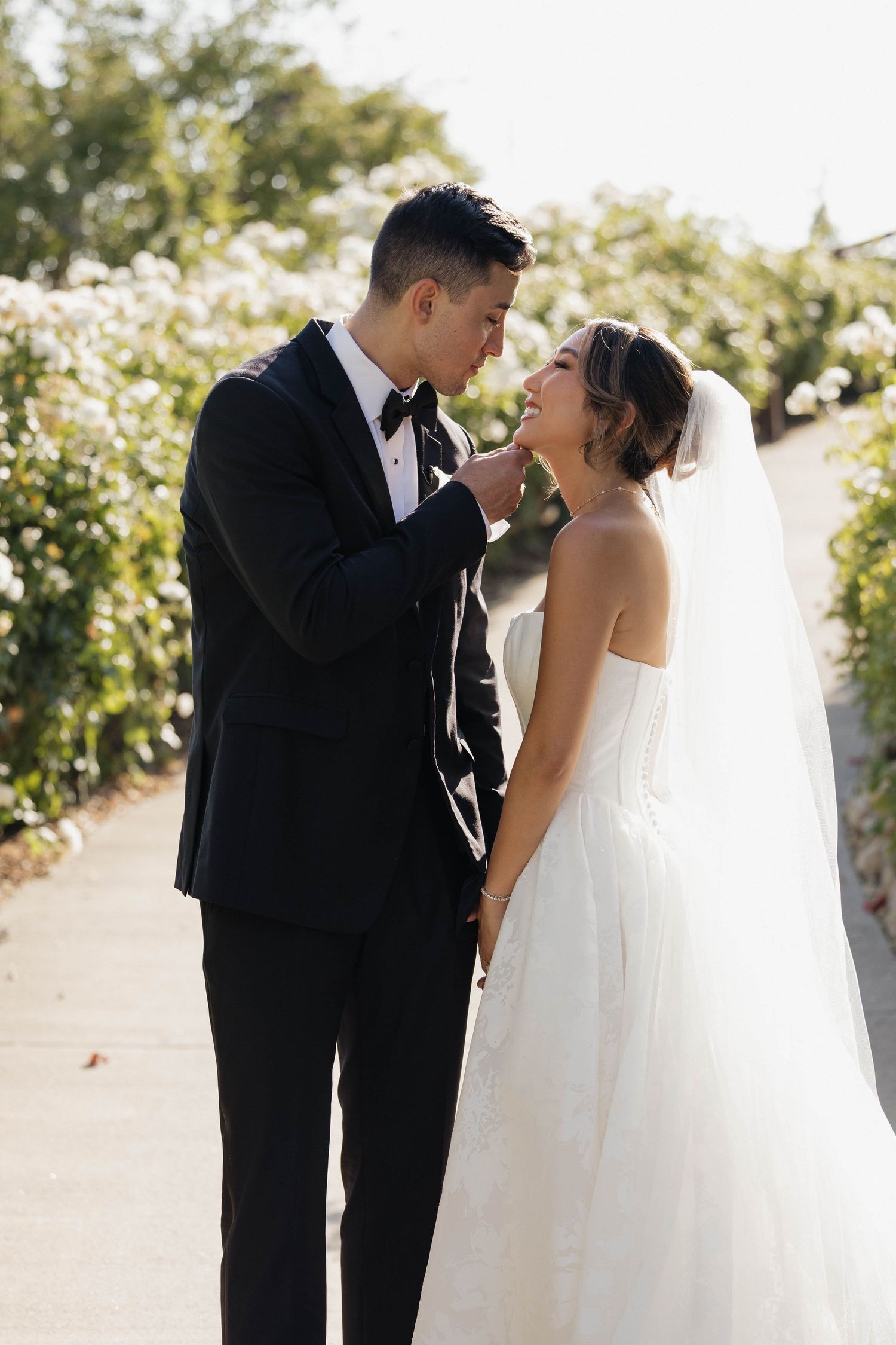 A golden hour wedding photoshoot capturing intimate moments between a couple in formal attire.
