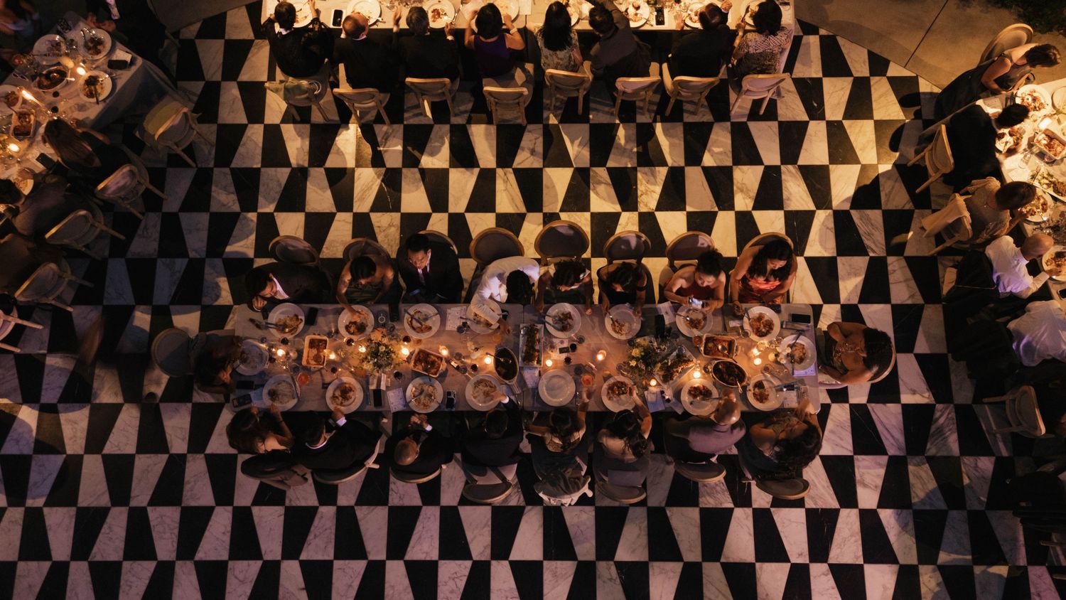 A decorative black and brown checkered pattern creates an abstract background design.