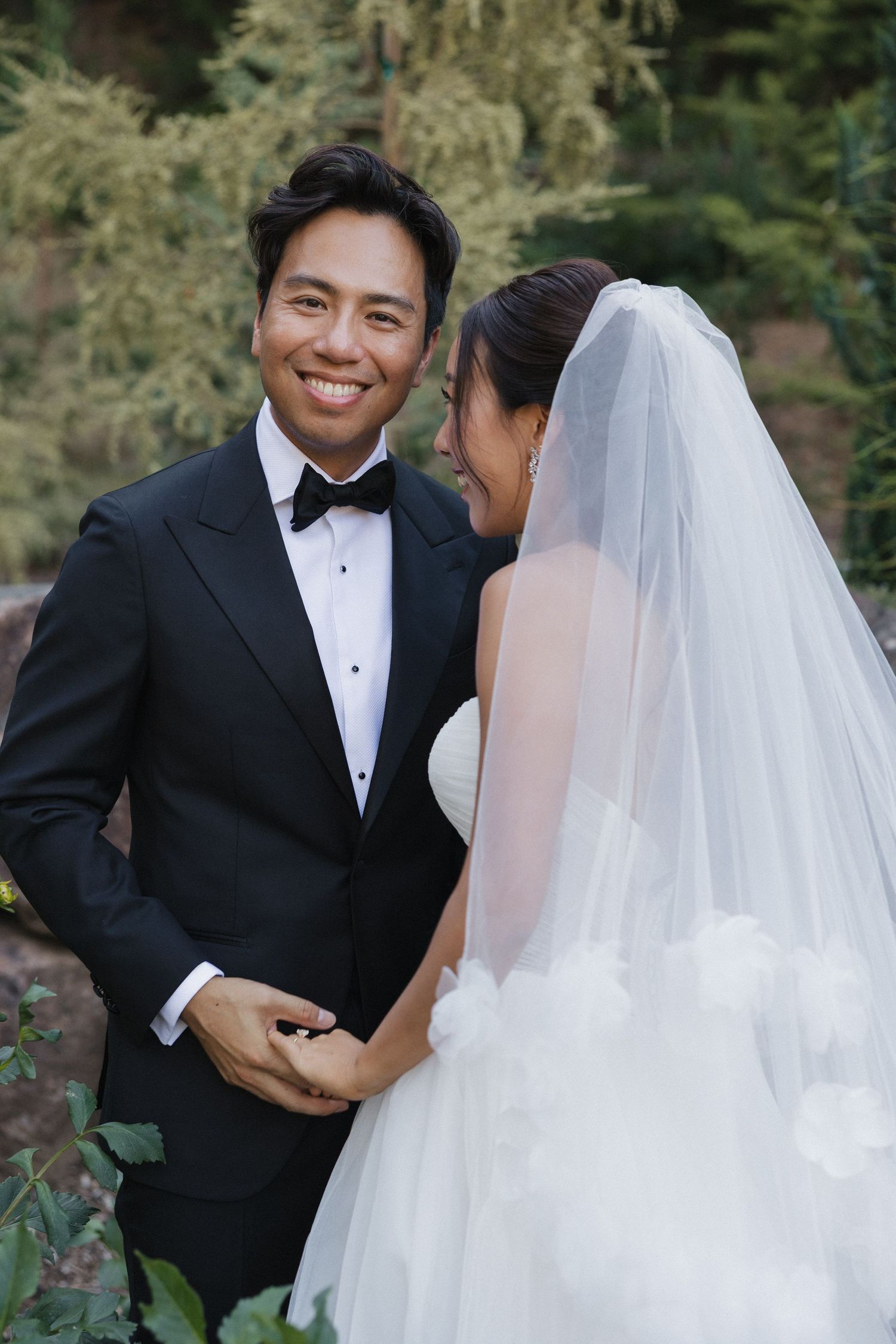 A bride and groom share intimate moments during their outdoor wedding photo session.