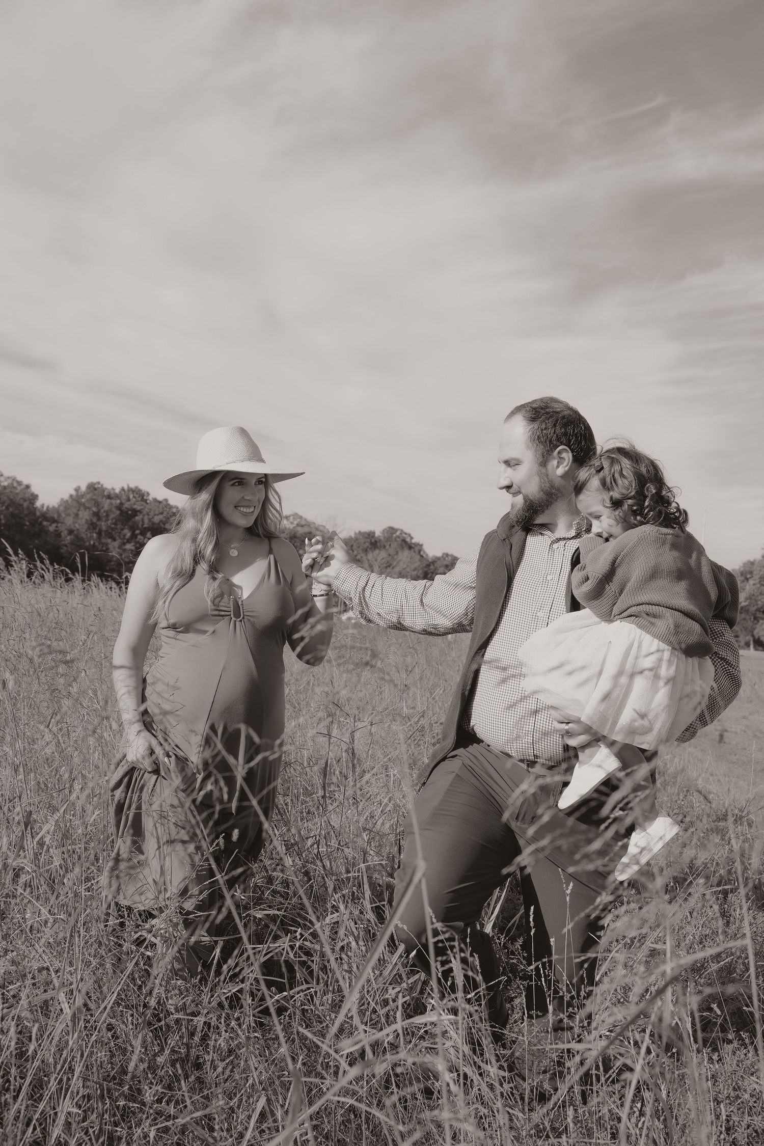 Black-and-white couple dancing in meadow during engagement session | Manassas, Virginia engagement photos.